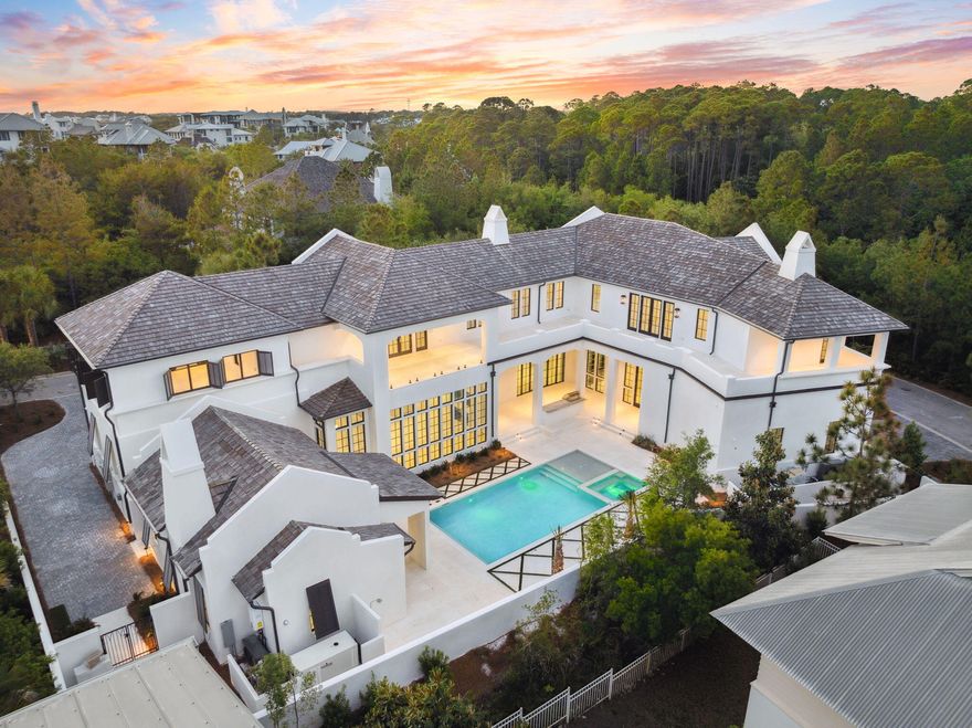 Set on the largest homesite in The Retreat, this striking new construction home offers an unmatched blend of scale, sophistication, and privacy. Positioned on a rare double lot spanning just under half an acre in one of 30A's most exclusive gated communities, this resort-style residence delivers a modern coastal lifestyle at the highest level. Encompassing over 7,000 square feet, the main home features 5 spacious bedrooms and 5.5 luxurious bathrooms, while a separate 1-bedroom, 1-bathroom carriage house near the pool offers private accommodations for guests or extended stays. From the moment you enter, it's clear no detail has been overlooked Venetian plaster walls, floor-to-ceiling windows, and sleek, modern finishes are showcased throughout the home, creating a refined yet comfortable living environment.

At the heart of the home, a showstopping double island kitchen combines custom cabinetry with high-end appliances, offering both functionality and striking design. Expansive living and dining areas open to a central courtyard, where a resort-style pool, grilling area, and ample lounging space set the stage for elevated indoor-outdoor entertaining.

Additional features include two separate garages for abundant parking and storage, along with an expansive paver motor court for guests. Every inch of this home has been thoughtfully crafted to balance beauty and utilitydelivering an extraordinary opportunity to own one of the most refined and well-designed homes in The Retreat.