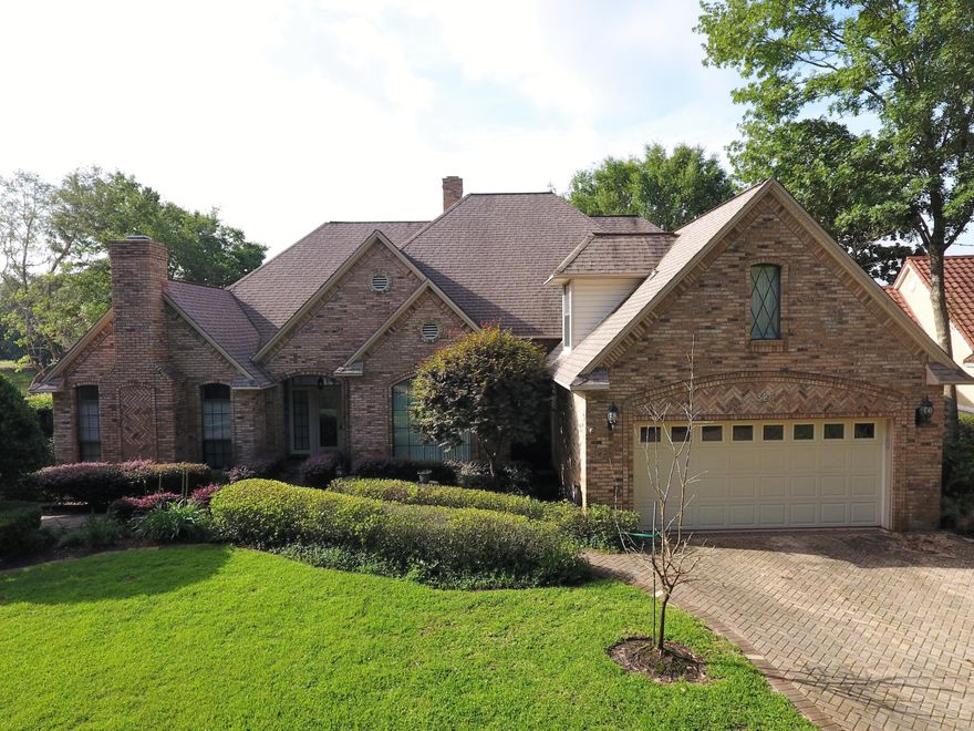 This beautiful lakefront home on a picturesque manicured lot has 106 feet of water frontage! Large windows across the back of the home capture the panoramic views which can also be enjoyed from multiple rear paver patios and walkways. The living room/dining room are an open floor plan with the kitchen/family room open as well and a double-sided fireplace separating the living room and family room. The office features a second fireplace and a nook for an additional desk or storage space. The large kitchen was updated recently with new cabinets, a Wolf gas cook top and Wolf electric wall oven, new LG refrigerator in 2016, Calcatta Gold Quartzite countertops and tile backsplash. The master bath was also recently updated with tile shower, whirlpool tub, double sinks and granite countertops.