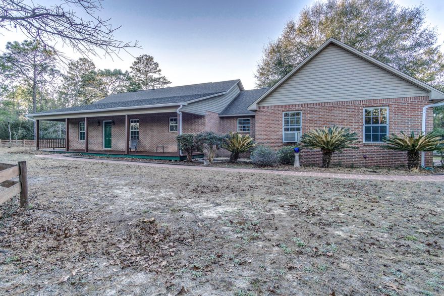 Ah, country living, for sure. Nestled in a wooded 4 acre lot is this well-kept 3 bedroom, 2 bath house with a large very well done converted garage used as a bonus room or ''man-cave''. The bedrooms are of ample size, clean kitchen with updated appliances to include a double oven. There is genuine wood flooring in the loving room and hallways leading to the bedrooms and tile in the kitchen and bathrooms. What is really great about this home are the over-sized porches in both the front and back of the home for relaxing outdoors at any time. Don't forget that you have a concrete salt water swimming pool to cool off in during the hot summers. There is added storage in the out building and a feeling of security being tucked behind trees away from the main road. Consider this home for yo