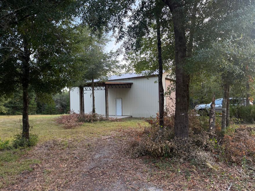Looking for a place to store your RV, a rare find just under 5 acres, with power, a 24 x 48 metal building  on a concrete pad, a 14' w x 16' h roll-up door and  a separate front entry  door with a covered porch.    There is an old  existing septic tank on the property but has never been used and a well but is not in operation.  The remainder of the property is wooded and is zoned  ESTATE RESIDENTIAL.Buyer(s) are responsible to personally verify all details for property and dimensions. Any information contained in this listing is believed to be accurate but is not guaranteed.
