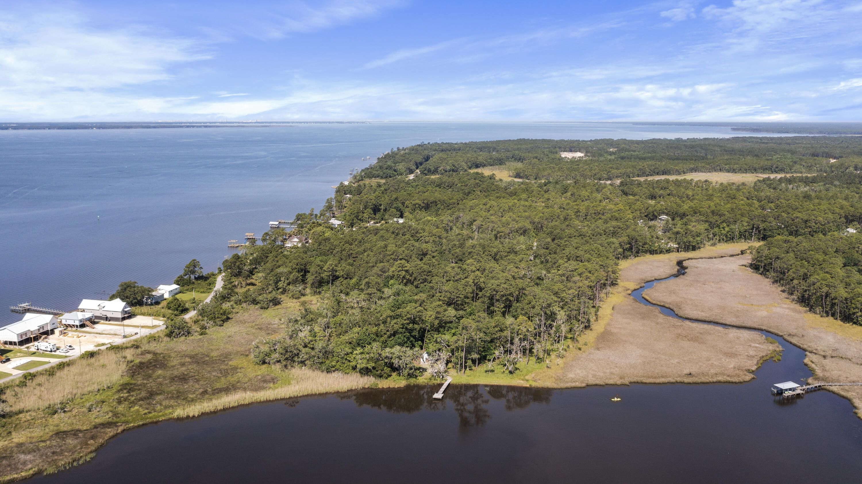 Introducing two parcels totaling 4.22 acres, with nearly 300 feet on Lagrange Bayou and over 600 feet from the property entrance to the shoreline. One of the parcels is part of Cross Creek Shores, which has underground utilities including city water/sewer and restrictive covenants to protect your property value. (There are no HOA fees.) The adjacent included parcel has a deep-water dock and a small outbuilding for storage. A large marsh to the north and a large undeveloped parcel to the south provide exceptional privacy. Dozens of beautiful hardwood trees dripping with Spanish moss create a serene backdrop for the waterfront estate of your dreams, or subdivide into multiple homesites.