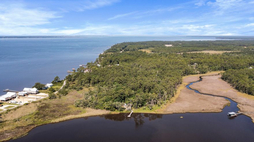 Introducing two parcels totaling 4.22 acres, with nearly 300 feet on Lagrange Bayou and over 600 feet from the property entrance to the shoreline. One of the parcels is part of Cross Creek Shores, which has underground utilities including city water/sewer and restrictive covenants to protect your property value. (There are no HOA fees.) The adjacent included parcel has a deep-water dock and a small outbuilding for storage.  A large marsh to the north and a large undeveloped parcel to the south provide exceptional privacy.  Dozens of beautiful hardwood trees dripping with Spanish moss create a serene backdrop for the waterfront estate of your dreams, or subdivide into multiple homesites.