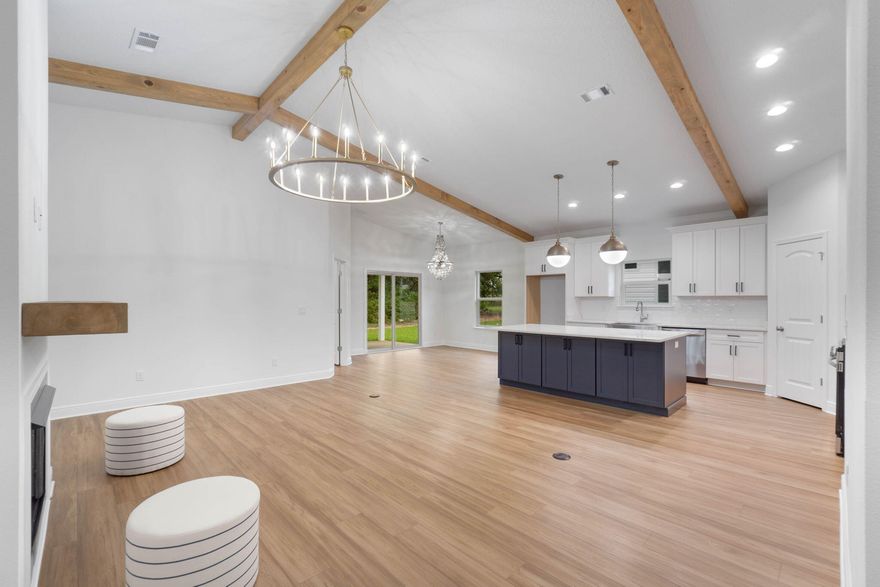 Set on an oversized lot just under half of an acre, this will be newly built Craftsman-inspired residence that offers an exceptional blend of refined design, quality craftsmanship, and modern comfort. With nearly 2,000 square feet of thoughtfully curated living space, this 4-bedroom, 2.5-bath home is designed for both elegant entertaining and everyday living. The interior makes an immediate statement with soaring vaulted ceilings, custom cypress wood beams, and a striking fireplace that anchors the main living area--creating a warm and sophisticated atmosphere. An open, light-filled layout enhances the home's elevated yet inviting aesthetic throughout. At the heart of the home, the chef-inspired kitchen features tall cabinetry, a gas range, and premium finishes, seamlessly connecting to the living and dining spaces for effortless flow. A tankless hot water system adds modern efficiency and everyday convenience. The primary suite is a serene private retreat, offering a spa-like experience with a freestanding soaking tub and a beautifully tiled walk-in shower. Additional bedrooms provide generous space and flexibility for guests, work-from-home needs, or creative use. 
Built by a respected family-owned builder known for integrity, attention to detail, and superior craftsmanship, this home reflects a level of quality that stands apart from typical new construction. This oversized lot offers rare space and privacyan ideal setting for outdoor enjoyment and future possibilities. This exceptional property delivers timeless style, modern luxury, and room to breathe. * THESE ARE STOCK PHOTOS- NOT ACTUAL LOT SPECIFIC FINISHES. BUYERS STILL HAVE A CHOICE OF EXTERIOR AND INTERIOR FEATURES AND FINISHES AND COLOR SELECTIONS AT THIS STAGE OF CONSTRUCTION*