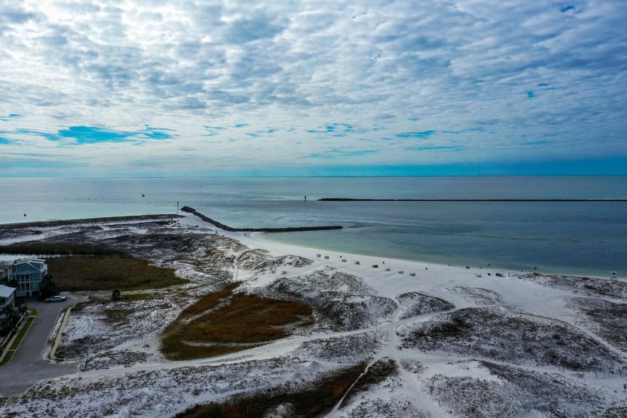 This BEAUTIFULLY Renovated townhouse located on Holiday Isle with deeded beach access is just steps from the beach.  This Stunning townhouse comes ''Completely'' furnished with all new furniture and smart TV's throughout. The renovations were completed in early 2021 with new vinyl plank waterproof flooring, new quartz countertops, all new appliances, ceiling fans and light fixtures throughout, plantation shutters, new paint throughout the home, new wood decking on the front and back with new deck railing. This would be a Great Investment with a rental projection of $64k or the perfect place to call home!  Enjoy beautiful sunrises from the front balcony and enjoy the evening walks on the beach to admire the beautiful sunsets.  Now's the time to invest in your own little piece of Paradise