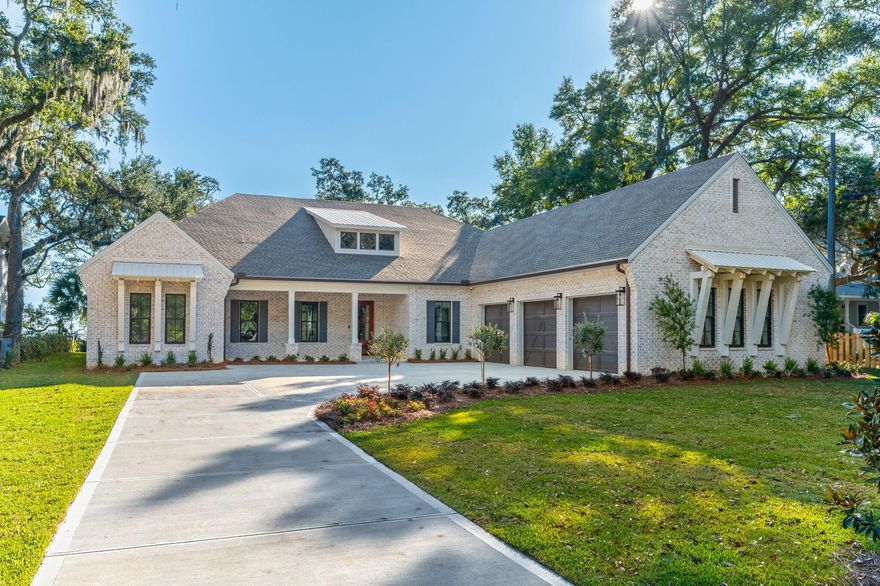 Set beneath a canopy of majestic and historic live oak trees and spanning approximately 90 feet of pristine deep waterfront on a 0.69 acre lot, this 4,176-square-foot brand new custom 2026 built home offers a rare blend of natural beauty, thoughtful design, and refined coastal luxury along the Santa Rosa Sound and Intracoastal Waterway in Mary Esther.Designed to honor its extraordinary setting, this elegant bayfront home captures sweeping water views from nearly every angle. Upon entry, expansive windows and carefully planned sightlines immediately draw your gaze to the Sound, where shimmering water and ever-changing skies become part of the home's daily rhythm. The open-concept living, dining, and kitchen spaces flow effortlessly together, creating an elegant yet inviting environment ideal for both relaxed living and effortless entertaining. Soaring 12 foot coffered tongue and groove ceilings enhance the sense of space while maintaining warmth with a touch of Southern charm. 

At the heart of the home, the chef's kitchen is a showpiece equipped with top-tier appliances including a six-burner Wolf range, Sub-Zero refrigeration, wine cooler, ice maker, and custom cabinetry. Whether hosting intimate gatherings or large celebrations, the kitchen and adjoining dining area highlighted by a distinctive brick accent wall offer a stunning backdrop of uninterrupted waterfront views.

The primary suite is a true private retreat, thoughtfully positioned in its own wing of the home. Vaulted ceilings, serene bayfront views, and direct access to the back patio create a peaceful escape. The spa-inspired ensuite features spacious dual vanities, a freestanding soaking tub beneath a stunning chandelier, a walk-in glass enclosed shower, private water closet, and an oversized custom closet designed for both form and function.

In total, the home offers four generously sized bedrooms plus a dedicated office, providing flexibility for guests, multigenerational living, or work-from-home needs. This home features a fantastic split floorpan with two primary suites, one in each wing.  Each space is designed with privacy, comfort, and timeless appeal in mind.

Outdoors, the waterfront lifestyle takes center stage. A welcoming outdoor fireplace sets the tone for evenings spent under the oaks, listening to the water and watching spectacular sunsets paint the sky. The expansive backyard offers ample room to add a pool and create a private outdoor oasis, along with space for a dock and boat lift, allowing effortless access to boating, paddle boarding, and life on the Sound. This property offers some of the deepest water in the an area for those who need deep water dockage due to its proximity alongside the channel.

This exceptional custom home is more than a residence--It's a legacy property, offering unparalleled views, historic natural surroundings, and the very best of coastal living. At the front(street side) of the lot, two additional coastal cottages are under construction offering you the possibility of purchasing all three properties if you need a mother in law home or additional investment properties. The additional two homes are not included in this sale and will be sold separately. 
