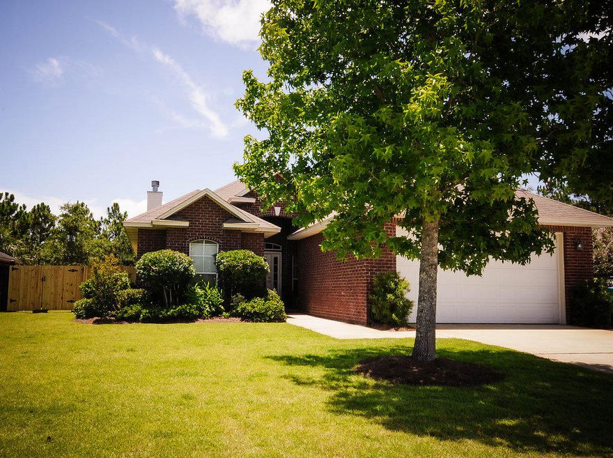 Come see this Bay Pointe custom three bedroom home with a bonus room in Quayside Village, a quaint sound side subdivision. Entry foyer features arches, columns and tray ceilings with recessed lighting. Bonus room has recently installed dark hardwood flooring and can serve as a bedroom, office, or formal dining room. Family room has double tray ceiling, recessed lighting, custom built shelving, fireplace, and french doors leading to covered lanai. Kitchen is open to family room and has a breakfast bar plus dinning area and is equipped with stainless appliances and includes decorator lighting, alcove pantry, and garbage disposal. A powder bathroom in the hallway leads through the hallway to laundry room, which has cabinets and soaking sink. Luxurious master bedroom has a sunlit sitting area with french doors out to covered lanai.  The ambiance is accented by recessed lighting, decorator ceiling fan, and doubled tray ceiling.  Master bath has cultured marble shower, large whirlpool soaking tub, cultured marble double vanities, and a spacious walk-in closet.  The professionally landscaped yard includes privacy fencing around and decorative fencing in the back to enjoy the natural landscape from the covered lanai in the back.  Sellers will include outdoor playground equipment upon acceptable offer and will offer a negotiable allowance for flooring based upon offers.