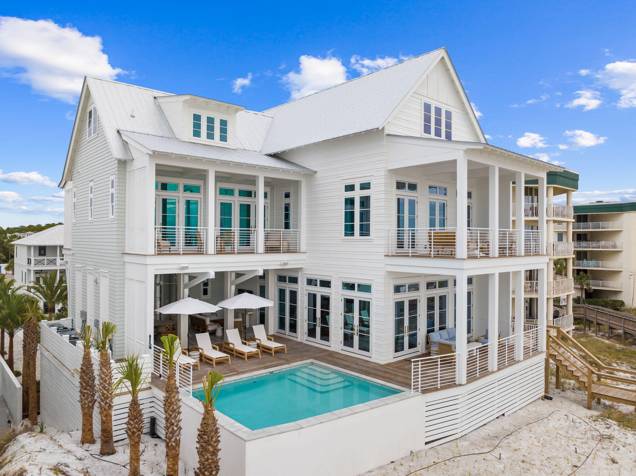 Envision the epitome of luxury and serenity at this exquisite new construction beachfront haven by renowned architect Geoff Chick perfectly situated on the pristine sands of the Emerald Coast. Boasting an impressive 7,911 square feet of elegantly designed living space and thoughtfully furnished by sought-after interior designer Ashley Gilbreath, this home is a masterpiece of comfort and sophistication in the coastal community of Seagrove Beach on 30A.With a grand total of 8 well-appointed bedrooms plus a charming bunk room, and 8 lavish bathrooms, this property is tailored for both privacy and grand-scale entertaining. The kitchen and main living room share the 2nd floor along with the Gulf-front heated saltwater pool and outdoor kitchen with the primary bedroom on the 3rd floor. The accompanying carriage house with a 3-car garage adds a layer of convenience and opportunity for guest accommodations or a private retreat.
Every detail of this home reflects a lifestyle of uncompromising quality and leisure, from the elegant interiors to the lush outdoor living spaces. The heart of this home is directed towards the breathtaking views of the Gulf, with 68 feet of private beach frontage providing an exclusive escape to the sugar-white sands and tranquil turquoise waters. Wake up to the soothing sounds of the waves and end the day with spectacular sunset vistas from your own slice of paradise.
For those who seek relaxation without the sand, the heated saltwater pool promises year-round enjoyment, surrounded by expansive terraces that are a testament to indoor-outdoor living. A covered outdoor full kitchen ensures that al fresco dining is a breeze, allowing you to savor fresh meals under the stars with the soothing backdrop of the crashing waves.
Discover the pinnacle of Gulf front living on Scenic 30A - where luxury meets the laid-back charm of Seagrove Beach. Whether you're searching for the perfect family retreat or your next investment property, this isn't just a home; it's the start of your new coastal legacy where every moment is a treasured memory in the making.