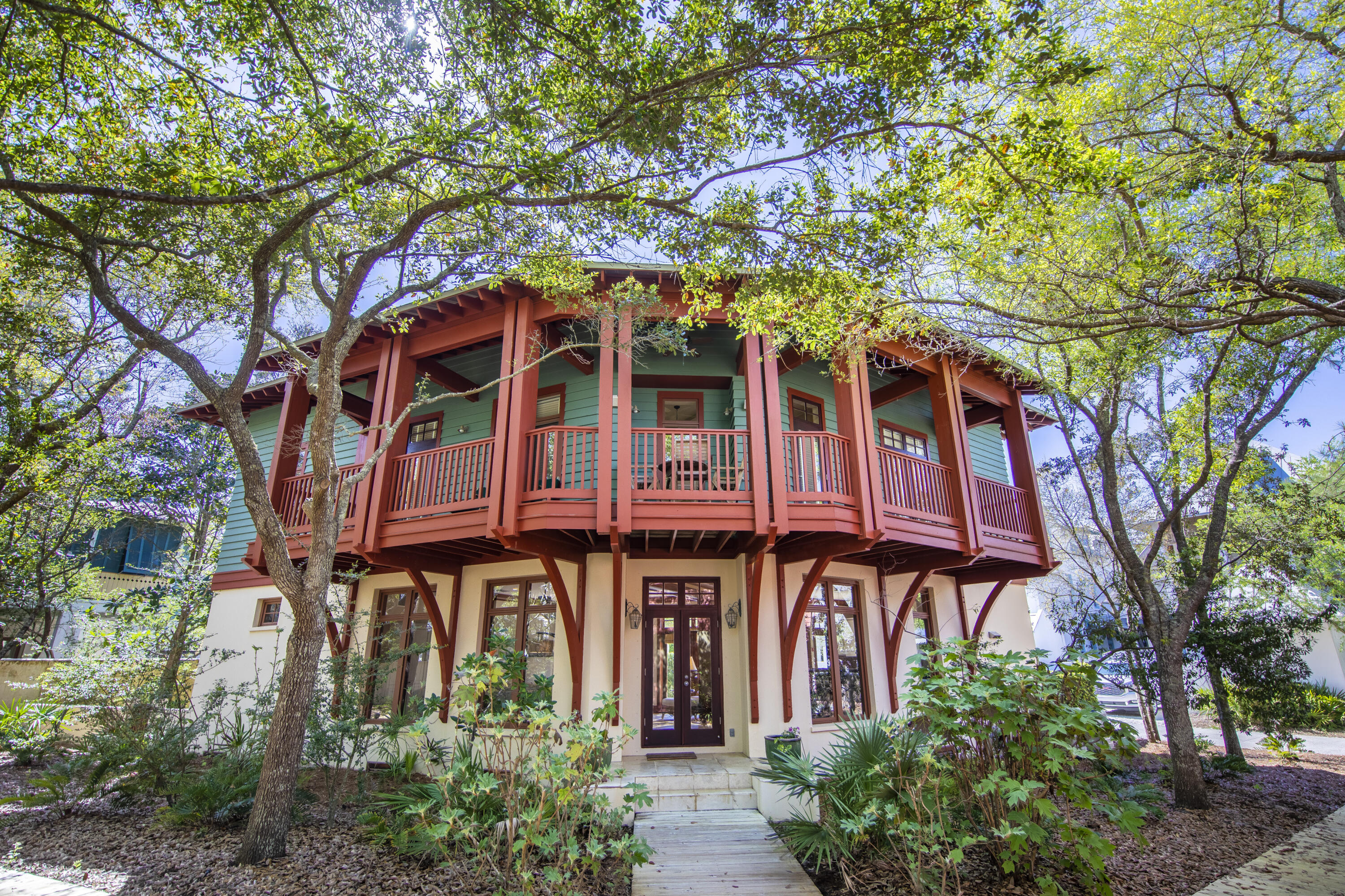 A quintessential Rosemary Beach home located next to the peaceful Triangle Park and just steps to East Long Green. Designed by Kirkland and Assoc. and built by Alana Ficarra, this three-story residence with three bedrooms plus an oversized bunk room, utilizes its location along two quiet boardwalks to maximize privacy - while inside the home it's easy to forget that you are just steps away from all the action of the Town Center! The open floor plan on the first level allows guests to interact seamlessly whether they are enjoying some sun on the back deck, preparing a meal in the kitchen, or socializing in the living room. This first level is flanked by windows, providing a spacious feel and an abundance of natural light. The natural hardwood stairs lead you up to the second floor where you