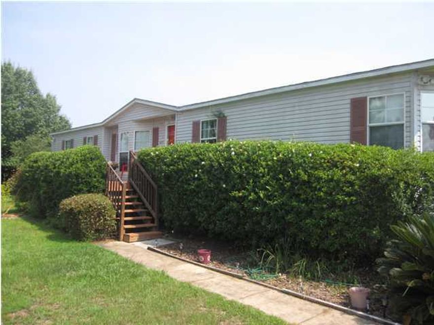 1769 Sq. Ft, 3 bedroom, 2 bath, manufactured home with many special features. Home features a new air handler. New decking on the porches This spacious open floor plan has a large family room w/fireplace and skylight transom, patio doors to deck, carpet, ceiling fan, special exhaust vent for air filtration and cathedral ceiling with crown molding. Open to the formal dining area and large kitchen with upgraded like new appliances, plumbing, breakfast bar, two freezers, vinyl flooring and kitchen pantry. Split bedroom floor plan with all bedrooms featuring ceiling fans and large walk-in closets. Master has bay window added feature for sitting area and additional lighting, master bath with 48'' separate shower,garden tub, double vanity, and lots of room. The additional bath has upgraded fea