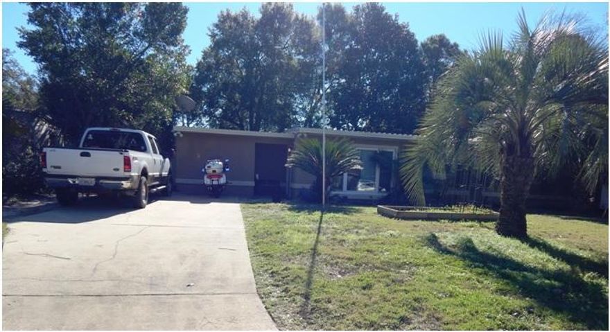 Well-Loved, Concrete Block, 4-Bedroom Home with New Metal Roof! This Wonderful home sits on a Large Lot in Elliott's Point! Close to Bases and Beaches! Recent improvements include new exterior stucco and bay window in 2009, tile counter tops & back splash, tile flooring in 2009, copper wiring in 2003, freshly painted, crown molding, new baseboards, plantation shutters, new lighting & fixtures, new wood flooring in 2014, new HVAC unit in 2014, new deck and awning in 2014, new metal roof and fence in 2014! There are two living areas! One is a large Living Room with Tile Flooring at the main entry and the other is a Family/Dining room with Beautiful wood floors, built-in Custom Wood Table and a Fireplace with antique mahogany surround! The Kitchen has