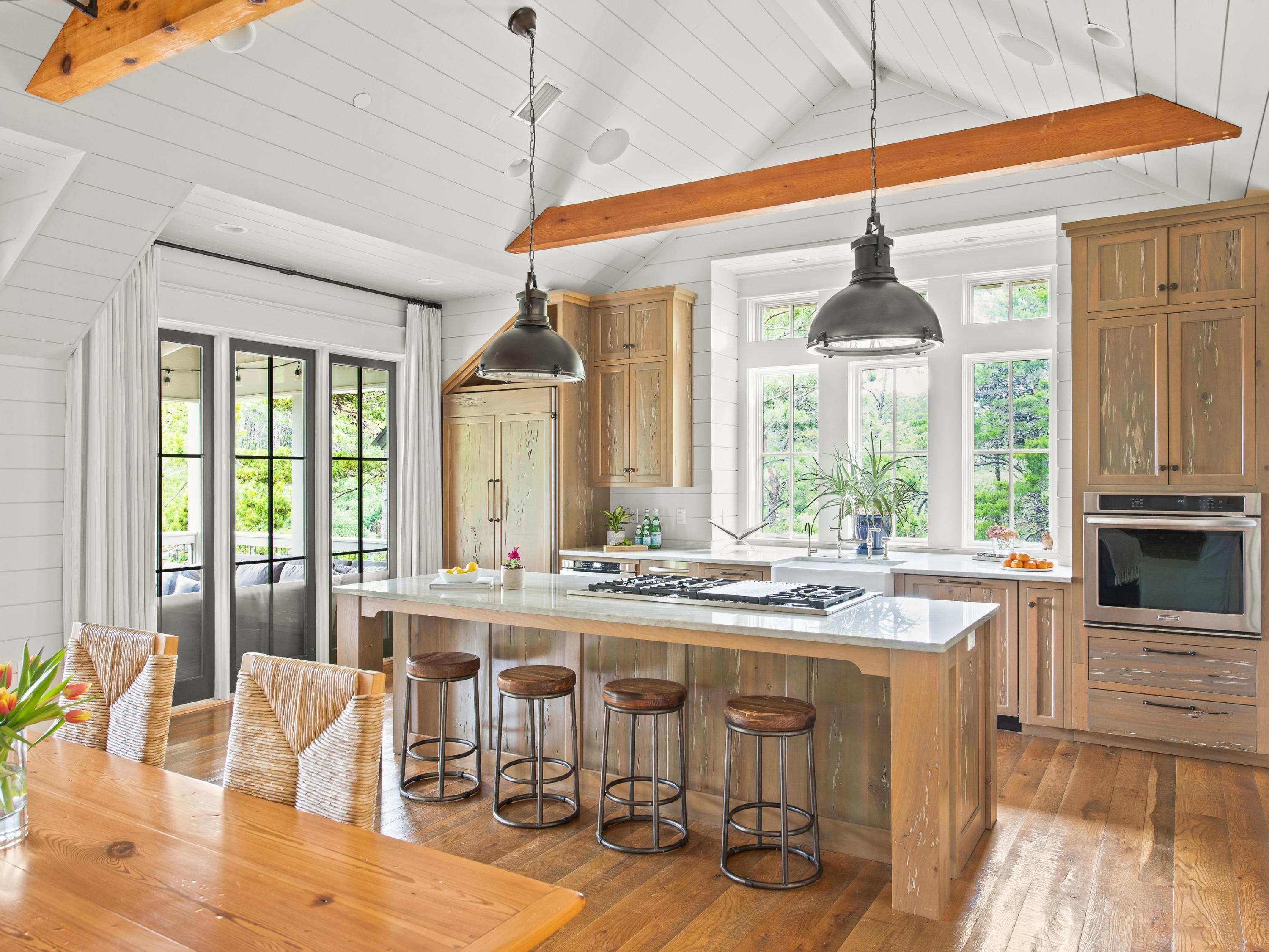 There are beach getaways and there are beach hideaways and this four-bedroom home in the rental-restricted neighborhood of Draper Lake Coastal Village is the epitome of the latter. Situated on a lush, wooded lot with views of Draper Lake, 16 Dewberry Lane was architecturally designed by Geoff Chick to convey character and to maximize relevant square footage where no space was wasted, with carefully curated decor and finishes from Urban Grace's Erika M. Powell. The first floor of this refined retreat nestled in the rolling topography of this exclusive neighborhood includes two bedrooms with ensuite baths and a bunk room with rustic, treated pecky cypress, all with rare coastal dune lake views.