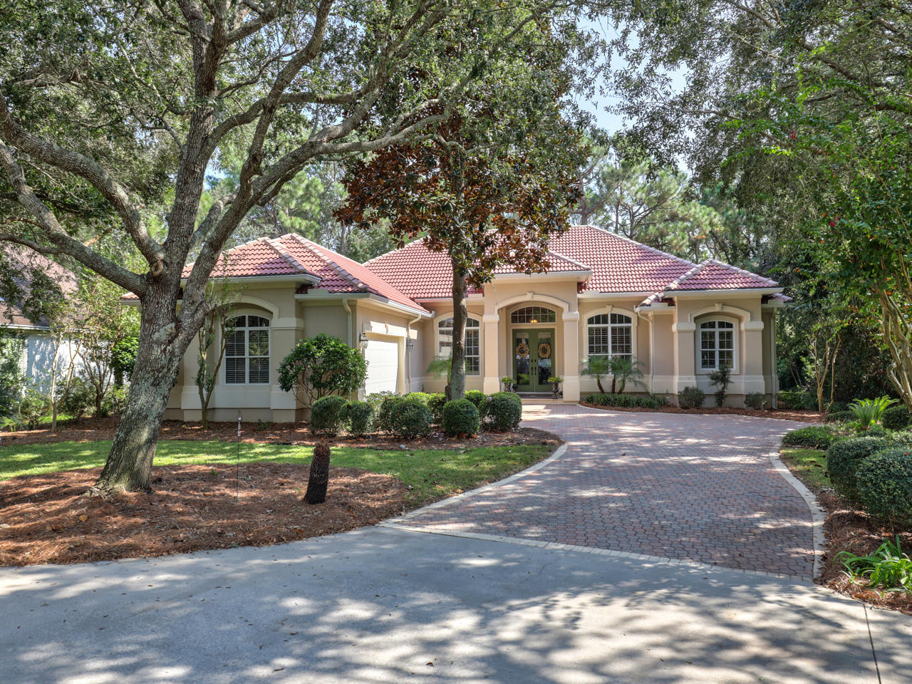 BEAUTIFUL stucco (hard coat) home located on a private cul de sac in the highly desirable gated, golf community of Kelly Plantation. The home backs to a nature preserve and has a 2 acre community green space located across from it. This quality built home boasts 3 BRs, 3 full baths & office that can also be a 4th BR. All on one story with a split BR plan, open kitchen, eat in area & family room as well as a separate living & dining room. Hardwood flooring in main areas with travertine bathrooms & laundry rm. Other features include high ceilings, 8' doors, crown moldings, plantation shutters & Hunter Douglas shades, a large screened in porch with a screened grilling area, stainless KitchenAid appliances, pantry, granite countertops, lg 2.5 garage, spacious laundry rm & great view.