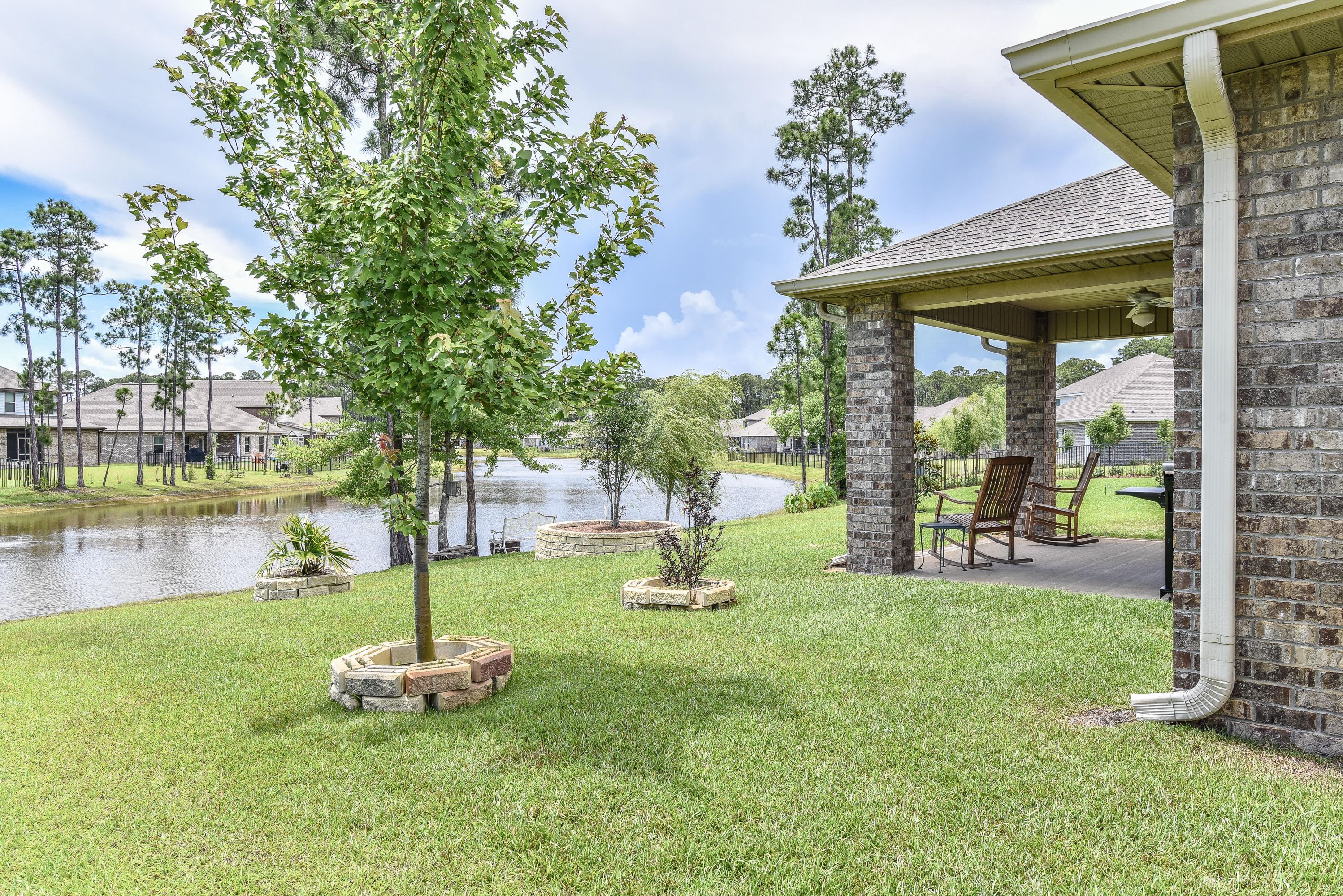 You will love this backyard overlooking the pond!Living is easy in this 1-story (no stairs to deal with) all brick ranch-style home with convenient access to shopping,restaurants,medical offices,and the BEACH! This home has an open floor plan with a fully-equipped kitchen that flows through to the dining room. The living and dining area opens up to a covered back porch looking the pond! The MBR is separate from the others and has double vanities, garden tub, and separate shower. It also comes with a BIG walk-in closet. There is a den upfront that could be used a home office or an extra bedroom (no closet).