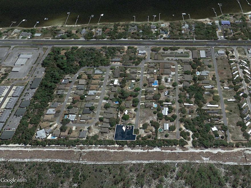 This large vacant lot in a quiet neighborhood is approximately one and a half miles west of the main gate of Hurlburt Field Air Force Base. It is bordered by government reservation land to the north for enhanced privacy. Utilities have been run on this cleared, fenced lot, located in Flood Zone X.