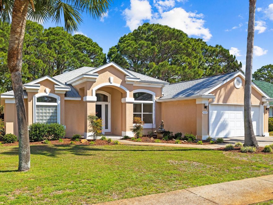 Sitting on a very private lot, this attractive ranch home has a great floor plan with lots of light and bright living spaces. The covered entrance opens into an expansive great room that flows naturally from the dining and sitting areas to a well-appointed kitchen and breakfast nook. New flooring and fresh paint give the entire living space a clean updated look. A three-way gas fireplace provides a cozy focal point while deep tray ceilings add to the sense of airy spaciousness. New LVP flooring adds to the synergy of this well-planned living space which flows naturally into the large open kitchen with breakfast bar seating. Stainless steel appliances, including a French-door refrigerator, complement warm wood cabinets and a stone-tile backslash. A newer front-loading washer and dryer are also included in the sale. Large sliding doors in the living/dining room and master bedroom open into a generous screened patio. This covered outdoor living space overlooks a fenced rear yard with a barbecue area for sharing happy times with family and friends. Laid mainly to lawn and backing onto woods, it's the perfect playground for kids and pets. There's ample space to add a pool, if desired. Three generous beds and two baths include a covetous master suite with a twin vanity and whirlpool tub in the oversized bathroom. The dining room could be re-purposed as a fourth bedroom if required.  Close to Destin beaches, golf courses and Choctawhatchee Bay, this well-proportioned home is in a prime location.  The spacious two-car garage is kitted out for use as a workshop or game room, still leaving ample space for beach toys, vehicles and golf carts. 