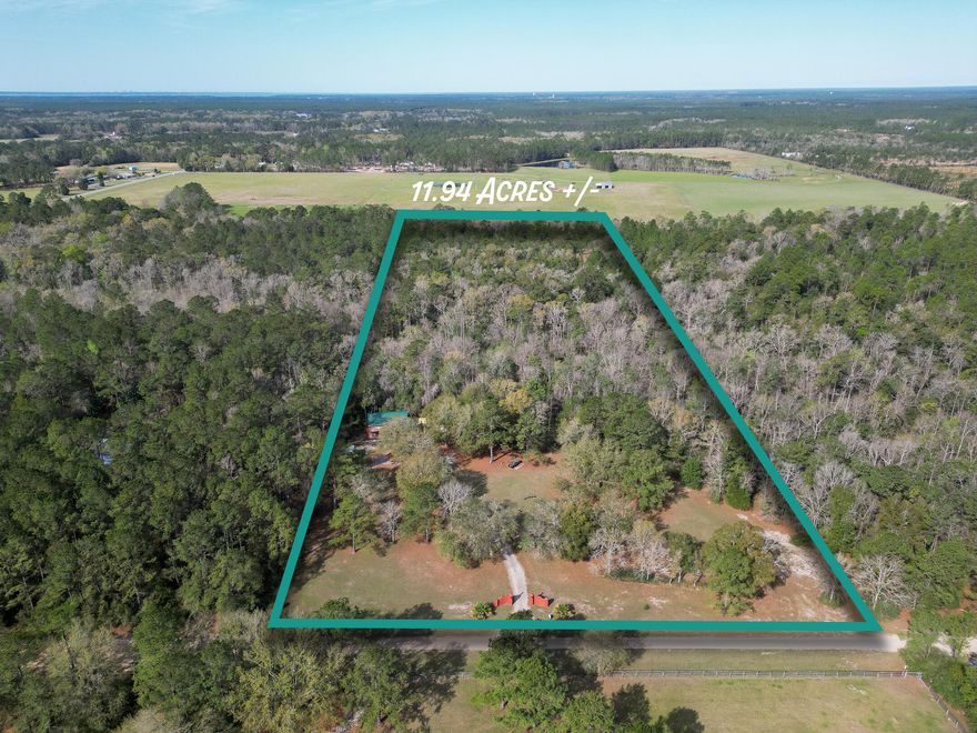 11.94 ACRES!   This lovely country setting is located within 4 miles of Freeport and within 20 miles of  the Beaches of South Walton  30A corridor. The front part of the land is cleared for the homesite, just behind the home is a spring fed stream, Joyce Branch, it runs through the property, beyond that, is the enchanted forest with horse/4-wheeler trails.  Electric, Water well and septic, with a new lift station, are in place.  The existing home was built in 2004 with 1 bedroom and 1 bath, later the garage was converted to a bedroom and bath making the house a 2/2 with 1437 square feet.  The property has 2 horse stalls, a tack room, a storage room and a slab with hookups for an RV.  Make this place your own, it has endless possibilities.  POSSIBLE OWNER FINANCING WITH 250,000 DOWN. Zoned Estate Residential - 1 home per 5 acres.  .  See land use info in documents.  No Survey.  Some wetlands located along Joyce Branch.  Buyer to verify all that is important to them.  