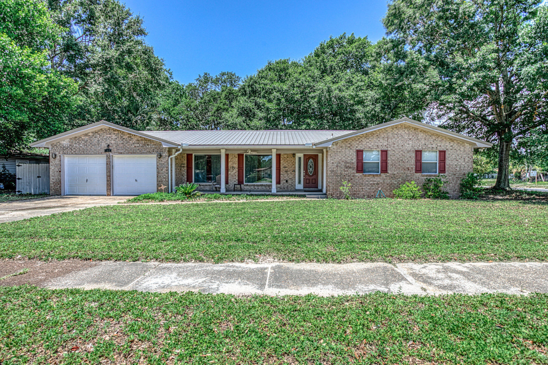 Beautiful open concept home that was fully remodeled in 2015. This home features spacious bedrooms, wood look tile, and an impressive living room with a wet bar, wine fridge, large windows & an open floor plan. The home has beautiful solid wood cherry cabinets w/ 42'' uppers, granite counter tops throughout and all stainless-steel appliances. Kitchen boasts plenty of space and includes a large island with plenty of storage. The Master Bath has double vanity and a cultured marble shower surround. The double garage w/ extra work space is insulated, finished & has attic access for extra storage. Big fenced yard with patio could be great for entertaining or enjoying the privacy of your back yard. Home also has a metal roof installed in 2015 along with a 50 gallon water heater and 3 ton AC.