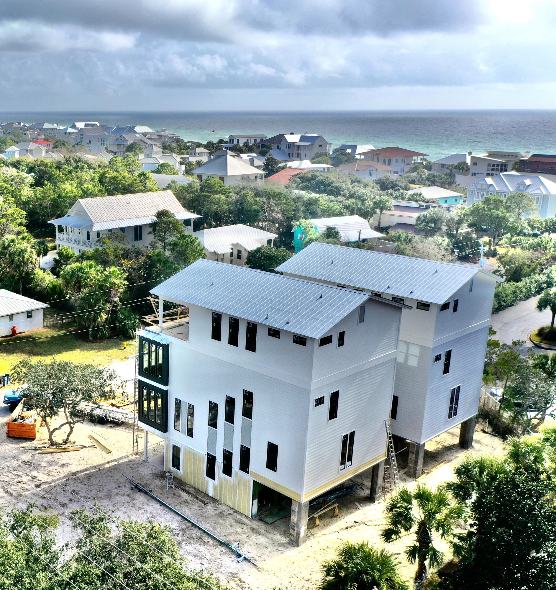 Gorgeous four-story rental dream under construction, south of 30A on Mary Street in Blue Mountain Beach. Take advantage of preconstruction pricing and add your personal touch to finishes.Perfect for indoor/outdoor entertaining, the first level includes a half bath and mini kitchen with a full sliding wall that opens to the pool deck. The second floor features the spacious kitchen, dining and living area, perfect for large families or parties to gather. The kitchen features Thermador appliances, a gas stove, ample counter space for serving, and a walk-in pantry. The third floor boasts a lovely master suite with a private balcony. Two guest suites with private bathrooms are also available on the third floor, one of which would be ideal for a multi-bunk room. The fourth floor boasts a second master suite, an additional guest suite with a private bathroom, and a large deck for entertaining and capturing amazing sunsets with Gulf views. The 30' by 16' deck will include a wet bar as well.

In order to service guests with ease, laundry rooms are located on the second and fourth floor. The home features an elevator as well servicing all floors.

The large pool will be partially shaded, bringing relief to the hot summer days. The pool deck will also have shaded areas to enjoy as well ample sunbathing space. The beach is just a short walk (less than 5 minutes). The two car garage will be ideal for parking in addition to storing anything you need from beach items to a golf cart.

Blue Mountain Beach is one of the best beach communities on 30A with less crowds on the beach, easy access to restaurants and entertainment.