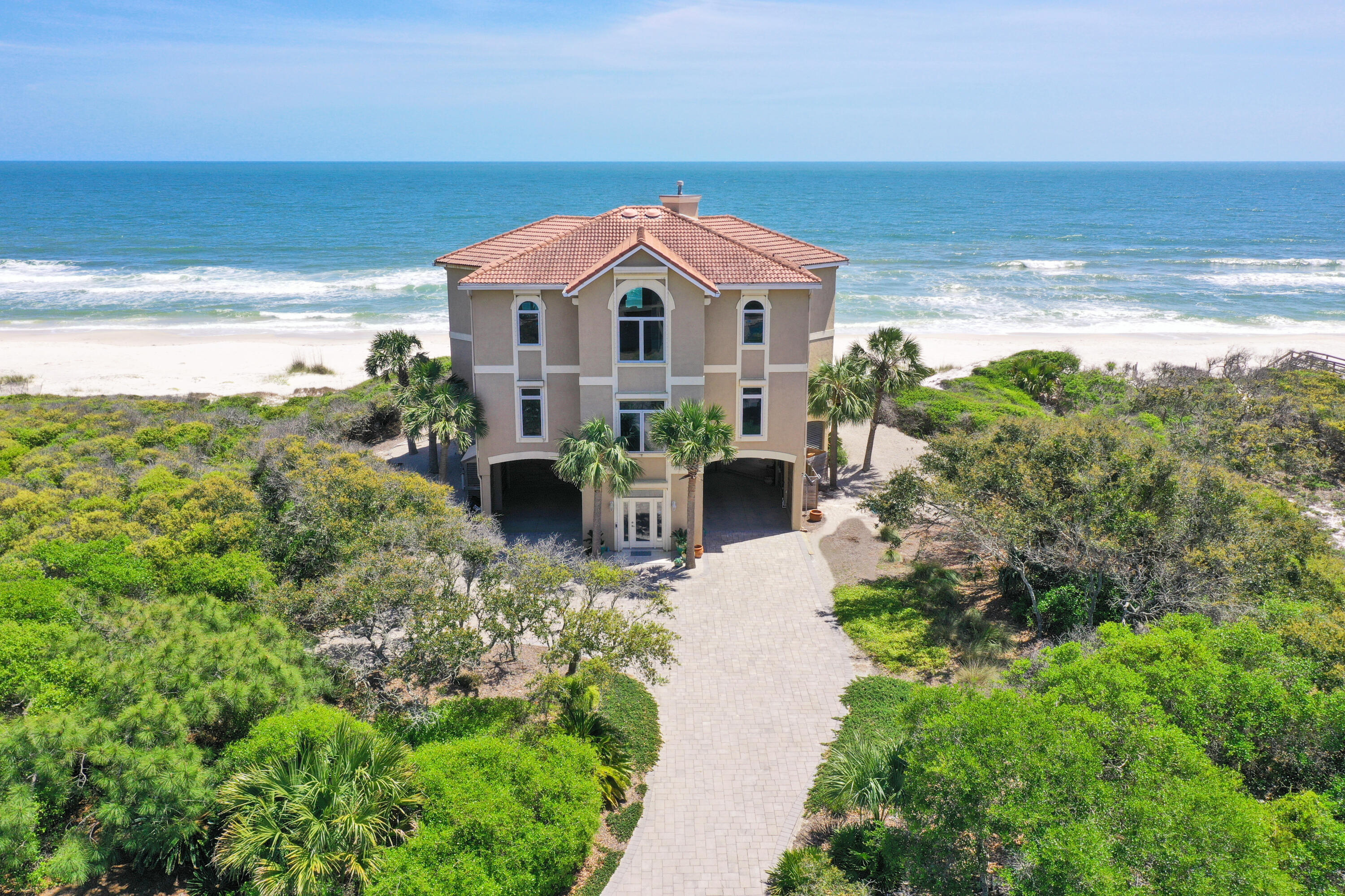 This remarkable 5 BR, 3.5 BA gulf front home is a custom built dream home located in the SGI Plantation. By far one of the most spectacular views on the island! ''Windsong'' is graced with soaring ceilings & enormous windows with 180 panoramic views overlooking the Gulf of Mexico. The spacious layout affords ultimate privacy w/ four bedrooms on the 2nd level w/ their own living space, 2 large full bathrooms & a hobby/office niche. Wide open deck w/ swim spa & hot tub overlooks the beach! A large primary bedroom, on the third level, is the ultimate retreat w/ built-in custom cabinetry & a relaxing spa-like bathroom. Luxurious chef's kitchen with state-of-the-art appliances & premium finishes.   Interior elevator too!