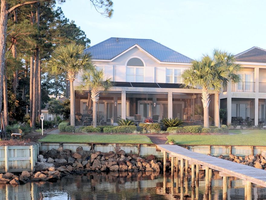 House is currently VACANT and easy to show. This is your opportunity to own a fabulous Florida Cottage Style Bayfront home located on the Choctawhatchee Bay in a wonderful community. The focus of the home design is to capture the amazing bay front view with an outdoor living space. You can certainly tell this home has been cared for with so much love. The downstairs floors are hardwood featuring an open concept allowing a bay view from the kitchen and living area. The kitchen features high end appliances and a great center bar with cabinets below. are right off the kitchen with a wine refrigerator, sink, cabinets, and washer/dryer. Directly in front of the washer/dryer is the large pantry area perfect for large appliances.