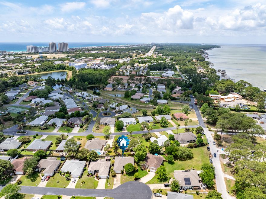 Location! Location! Location!  This beautifully detached single family home in the heart of Miramar Beach is located less than a mile from the Emerald Coast and less than a 1/4 mile from Choctawhatchee Bay.  Perfectly positioned between the bay and the coast, you choose your own adventure as both are just a few minutes drive.  What more could you ask for?  This 3Br/2Ba 1656 sq ft home is located in the idyllic neighborhood of Bayside.  The kitchen has been recently remodeled with a contemporary look featuring a seafoam glass backsplash, a perfect canvas balanced by modern stainless steel appliances and complementing recessed lighting above.  Entertain even the largest groups as you have tons of prep space with your large oversized kitchen island and ample counter space, all complete in white quartz.  

Your spacious living room has a warm wood-burning fireplace for those cold winter nights and for those warmer days, you have multiple ceiling fans throughout the home.  You'll find updated vinyl tile flooring throughout most of the home and your dining area has the most elegant pendant lighting with glows of amber and ivory tones.  Vaulted ceilings add that level of sophistication that makes this house feel like a home, one filled with natural light and spacious surroundings.  

Your primary bedroom is large enough for your king size bed and its complementing furniture and you have your own ensuite bathroom with tiled shower and dual vanities.  Walk out to your garden through your french doors where you can have a little sitting area, all while enjoying the ocean and breezes and finishing that book you've been wanting to complete.  

As a split-level floor plan, the other two bedrooms provide spacious room for your guest and/or family members, but also offering some privacy as these two rooms are near the front of the house.  There is another bathroom that can be shared between the two front bedrooms.   

You have plenty of space in your backyard to add your own garden flair as the sellers have quite a green thumb and will be taking their plants with them.  Beautiful trees and bushes outline the exterior front and back of the home with a beautiful brick paved patio in the back.

Bayside offers a large and well-maintained community pool, beautiful brick walkways and sitting areas.  Enjoy the shuffleboard and gazebo and there is a community dock, perfect for those who wish close access to water, one of the primary reasons for picking this beautiful home right in the heart of Miramar Beach!   With close access to shopping, entertainment, and schools, this home truly has it all.  