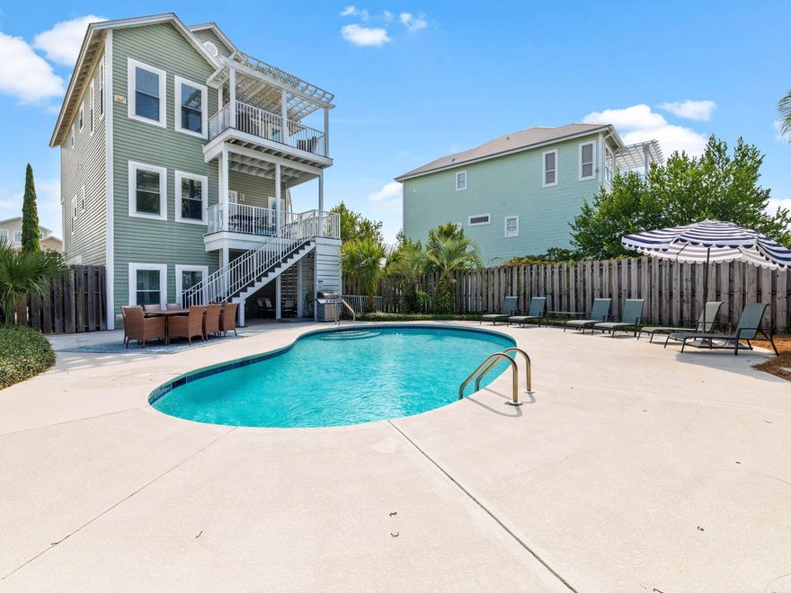 This quintessential beach house is located in Blue Mountain Beach, close to restaurants, shops and the 30A bike trail. Just a five-minute walk from the door, you'll find beach access for swimming and sunset strolls with pelicans and dolphins. Park in front of the garage, which is ideal for storing bicycles, beach toys or a golf cart. This beach house has a deceptively spacious interior boasting five beds, five baths, a spacious den and multiple outdoor porches. A half staircase leads up to the glazed front door. The ground floor has practical tile flooring, two sets of built-in bunk beds and a full bathroom. There's also a kitchenette with a breakfast nook, allowing guests to start the day at their own pace. Up one level, vinyl plank flooring leads to three good-sized bedrooms, two with direct balcony access, and stairs to the lower pool deck for a morning swim. Two full bathrooms and a laundry room also share this level. The third floor has a vaulted beamed ceiling and an open floor plan for entertaining with magnificent gulf views through the tall windows. The floor plan flows from the open-concept kitchen through the dining and living areas. Cooks will be keen to create their favorite recipes in this pristine kitchen, which boasts white quartz countertops, stainless appliances and a custom breakfast bar. Doors open directly onto a large, partially covered deck overlooking the private pool and sun deck below. Also, on the top floor, the master suite enjoys the best gulf views from a sun-kissed private balcony. Fully furnished and rental-ready, this versatile beach house would make an attractive investment or second home. Covering almost a quarter-acre, the fenced backyard has an oversized heated pool for kids to splash and play while adults relax and unwind.