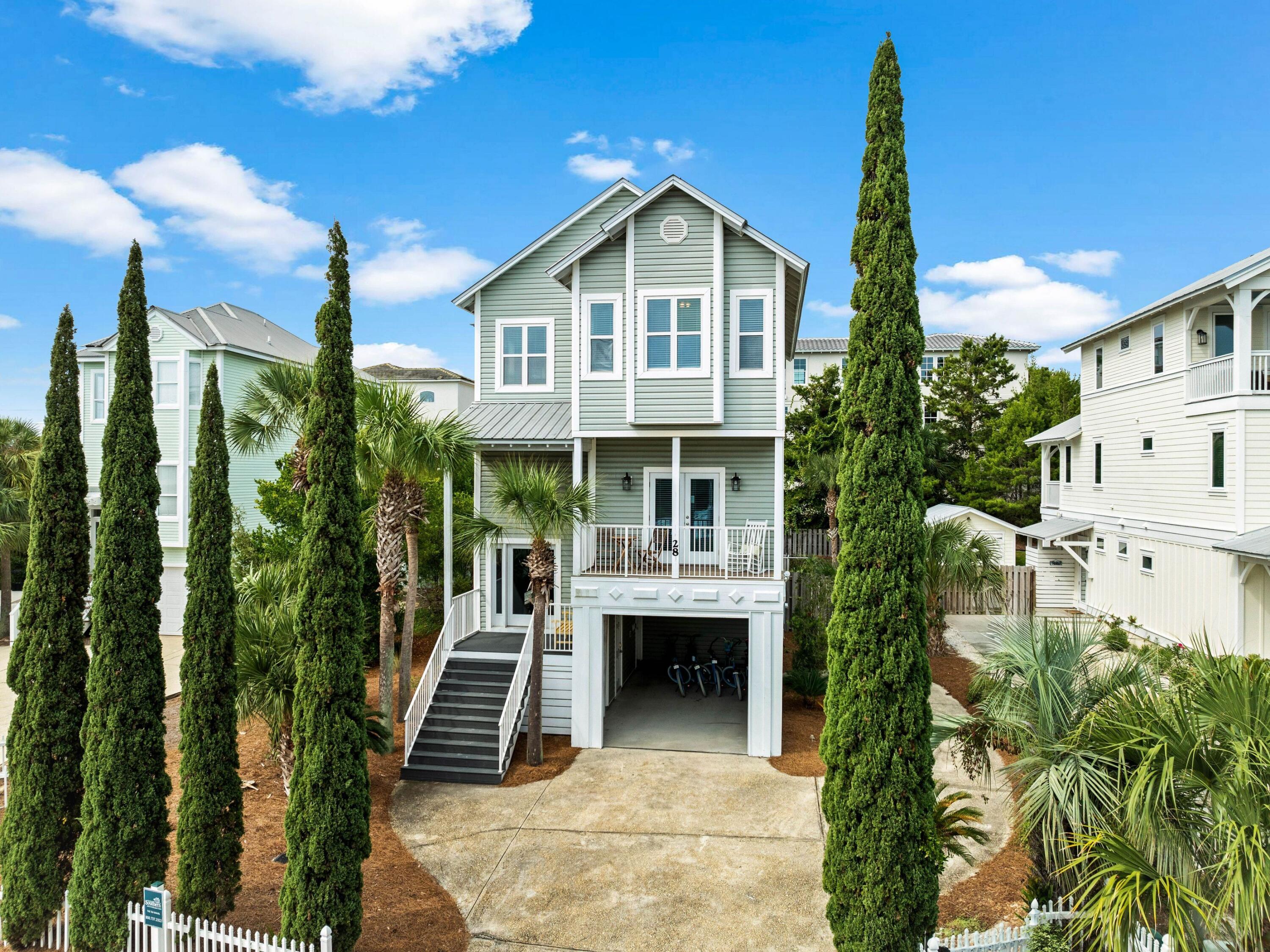 This quintessential beach house is located in Blue Mountain Beach, close to restaurants, shops and the 30A bike trail. Just a five-minute walk from the door, you'll find beach access for swimming and sunset strolls with pelicans and dolphins. Park in front of the garage, which is ideal for storing bicycles, beach toys or a golf cart. This beach house has a deceptively spacious interior boasting five beds, five baths, a spacious den and multiple outdoor porches. A half staircase leads up to the glazed front door. The ground floor has practical tile flooring, two sets of built-in bunk beds and a full bathroom. There's also a kitchenette with a breakfast nook, allowing guests to start the day at their own pace. Up one level, vinyl plank flooring leads to three good-sized bedrooms, two with direct balcony access, and stairs to the lower pool deck for a morning swim. Two full bathrooms and a laundry room also share this level. The third floor has a vaulted beamed ceiling and an open floor plan for entertaining with magnificent gulf views through the tall windows. The floor plan flows from the open-concept kitchen through the dining and living areas. Cooks will be keen to create their favorite recipes in this pristine kitchen, which boasts white quartz countertops, stainless appliances and a custom breakfast bar. Doors open directly onto a large, partially covered deck overlooking the private pool and sun deck below. Also, on the top floor, the master suite enjoys the best gulf views from a sun-kissed private balcony. Fully furnished and rental-ready, this versatile beach house would make an attractive investment or second home. Covering almost a quarter-acre, the fenced backyard has an oversized heated pool for kids to splash and play while adults relax and unwind.