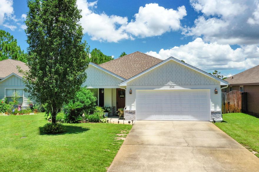 This House Is A WOW!! New Exterior Paint and Gorgeous Landscape Truly Makes This one a ''Honey Stop The Car''. LOCATION LOCATION - But Out of the Hustle and Bustle of Hwy 98. Convenient to Hurlburt Field and Just Minutes to Beautiful Navarre Beach and the YMCA! Sit on Your Covered Front Porch. This Home was the Former Model Home!  Upgrades include Beautiful Brazilian Hardwood, Granite Counters and 10ft Ceilings. Front Guest Room with Custom Bookshelves and Window Seat. Open Living and Dining. Kitchen has 35 sf of Counter Space, Custom Cabinets, Walk-In PANTRY, Stainless Appliances and a Breakfast Bar. Master Suite w/ Double Vanity, Walk-In Closet and access to Back Patio Oasis! Fenced Backyard with Covered Outdoor Living Area and Paver Walk. You Must See this Slice of Paradise! SEE MORE...