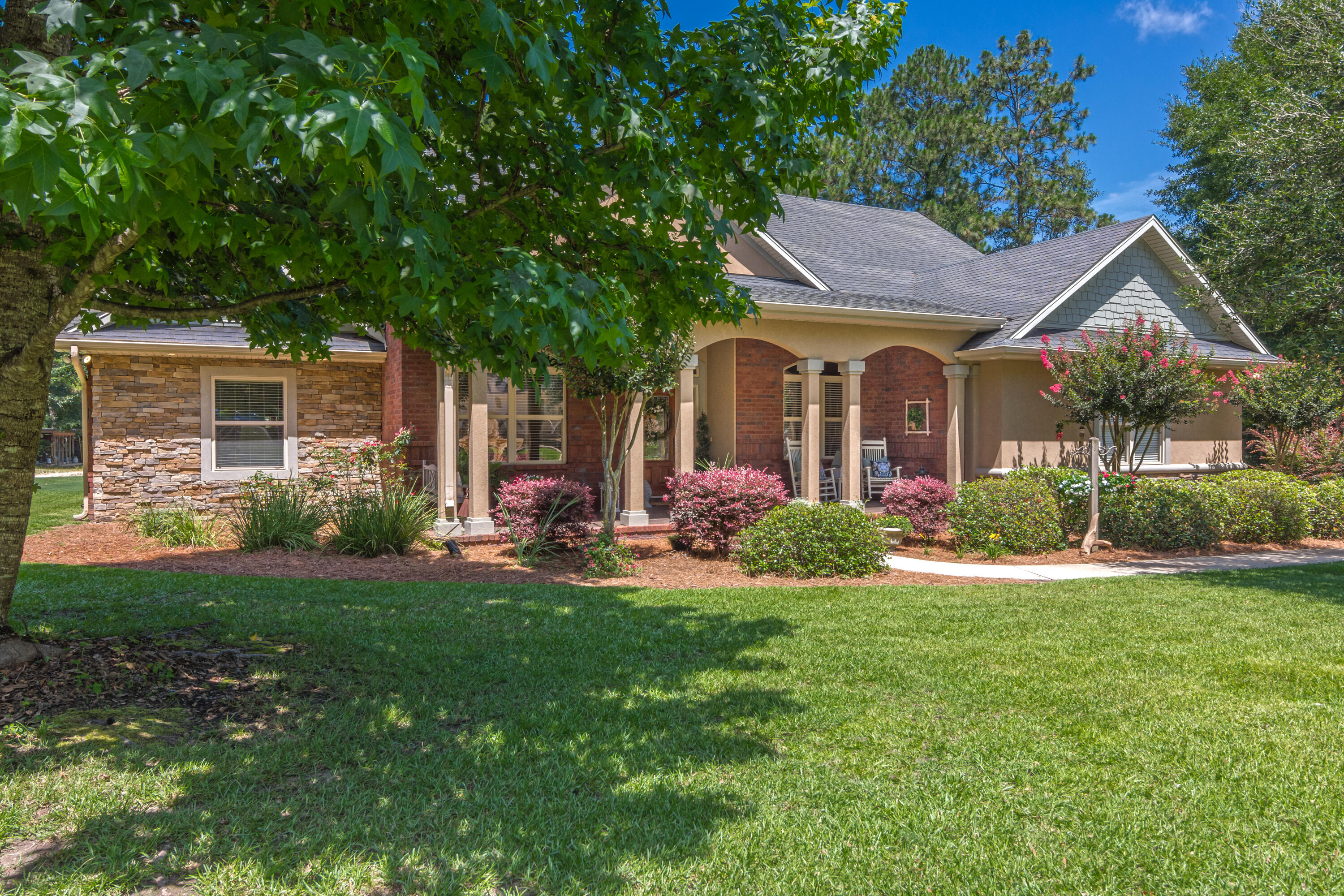 Welcome home to 6110 Blueberry Lane! Situated on over one acre in the beautiful Holly Hills area just off Lake Silver Rd, this well maintained traditional style 4 bd/2.5 ba home has so much to offer. With nearly 3,800 sq ft under roof and over 800 sq foot of covered columned porches featuring wood look tile, the home lives even more spacious than the heated and cooled portion. The porches are truly an extension of your living space. Inside the home, 12' elevated ceilings w/ large moldings will greet you in the foyer and living room. The living room features a floor to ceiling stone fireplace w/ dentiled mantle piece and both recessed can lights in addition to your overhead lighting. The formal dining room is adorned with columns and has a treyed ceiling. The kitchen sits between the