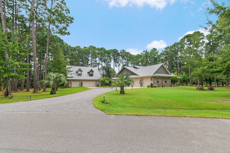 Your Beachside Bayou Escape Awaits! Embrace the coastal lifestyle in this beautiful 2-acre estate, perfectly positioned across from Lagrange Bayou and just a short drive to the sugar-white sands of 30A. With a main home and a full guest carriage house, this property offers space, style, and endless opportunities for relaxed living near the beach.The main home has 4 bedrooms, 2 baths, and an oversized 3-car garage. Inside, you'll find warm wood floors, crown molding, upgraded lighting and hardware, and a cozy fireplace for cool evenings. The kitchen shines with stainless steel appliances, solid surface counters, plenty of cabinetry, and a sunny breakfast nook overlooking the backyard. The spacious owner's suite includes a sitting area, large walk-in closet, double vanities, soaking tub, and separate tiled shower.
Step outside to your private fenced-in pool with lush, upgraded landscapingan ideal spot for afternoon swims or evening gatherings. The carriage house sits above a 3-car garage with workshop space/RV parking and offers 2 bedrooms, 1 bath, a full kitchen, dining, and living area. It's the perfect retreat for guests, multi-generational living, or even rental potentialcomplete with a brand-new AC unit for peace of mind.
With parking for 6+ cars, RV storage, and room to expand, this property blends comfort with functionality. Surrounded by bay views, boat launches, and just minutes from the beaches, airport, and restaurants, it's a one-of-a-kind gem designed for those who love a beachy, carefree lifestyle with space to spread out.