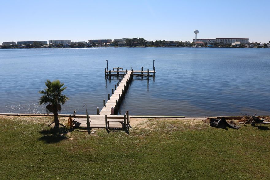 INVESTORS ALERT. Waterfront condo located on the sound. Fantastic price for this unit. Needs some UPDATES hence the price, new cabinets, counter tops, and maybe change the carpet to tile upstairs.  Relax on the balcony in this hidden gem with wonderful views of the sunrise and sunset. Unit is currently vacant ,easy show . Downstairs is tile throughout, upstairs bedrooms carpet .  Property comes with assigned parking, deck and sea wall as well as a grass lawn for those relaxing nights with friends and family.