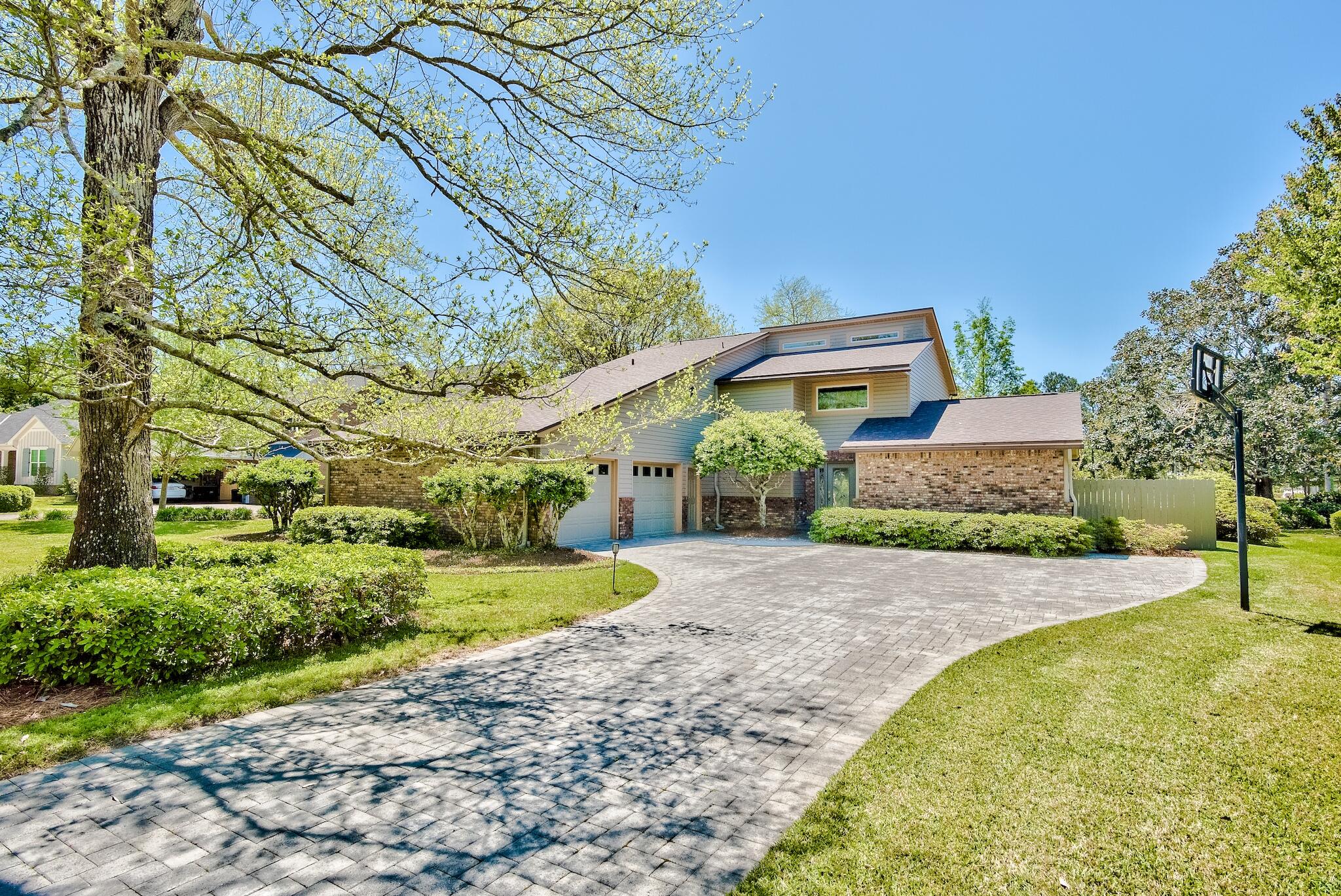 A lovely one-owner home so very well maintained and tastefully updated throughout the years is tucked away in a quiet small neighborhood. Appealing upon entering on the long brick paved drive and on through the beautiful glass doorway. The house lives large with a spacious great room with 25' ceilings that is open to the dining and kitchen. A wide staircase with a sunny landing leads to the very private master suite all with Brazilian wood flooring. The master bath has been updated with a walk-in Roman shower, double garden tub, private toilet and large walk-in closets. The closets extend to a heated and cooled 8'x13' room perfect for additional closet space, storage or crafting. Storage above the garage is accessible from this room. Also upstairs is a loft that makes a perfect study.
