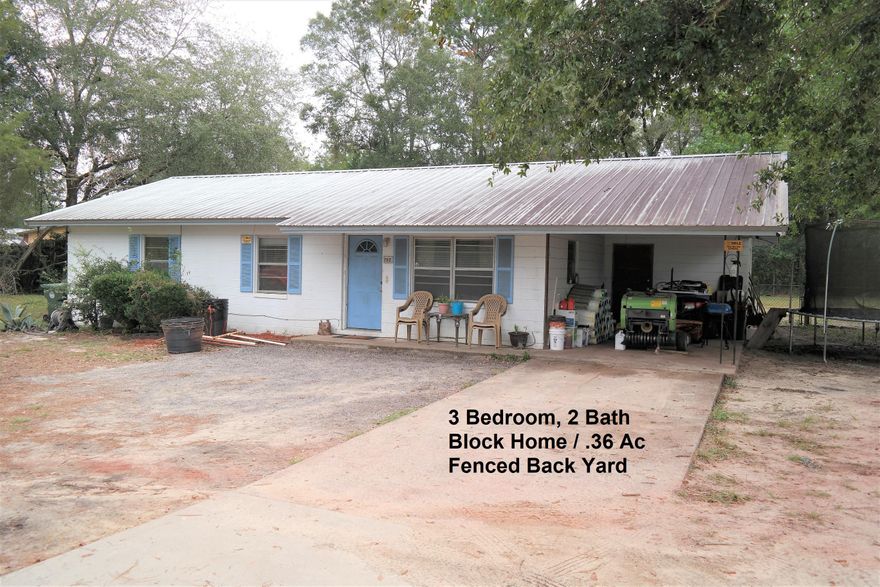 This 3 bedroom, 2 bath block home is a perfect first home or would make a great rental! Generous .36 acre lot with fenced back yard. Metal roof 2005; New HVAC Oct. 2019; New septic 2012; Drain field replaced 2019. Open floor plan and generous laundry/utility room off kitchen (can also be accessed from attached carport.  Located inside city limits, this home is convenient to schools, shopping, dining and I-10 is just minutes away!
