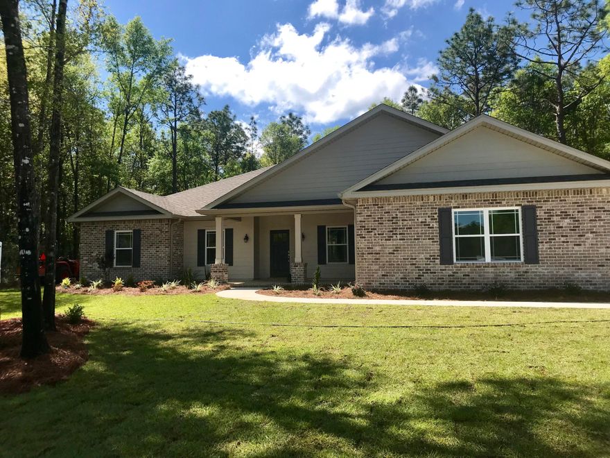 Upon a formal entry way you will find a flex/office room to the left and a formal dining room to your right. Enjoy an open concept living area to kitchen combo that is complete with an island and bar seating. The home comes standard with all weather tile flooring throughout in a warm shade of walnut. The kitchen maintains custom, white cabinetry with additional under cabinet lighting along with a walk in pantry, granite counter tops, and stainless steal appliances. The home features a split floor plan with the master bedroom on the left behind the kitchen. In addition, there is a charming sitting area in the master bedroom looking out over your half acre yard that provides plenty of natural lighting in the room. The master bathroom has a freestanding