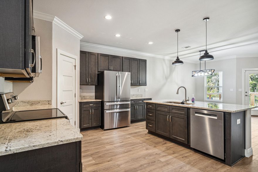 Welcome to this spacious 4-bedroom, 2-bath home lives large with soaring 9-foot ceilings throughout! The Master Suite is a true retreat, featuring a trayed ceiling for added height, a huge walk-in closet, and a luxurious ensuite with tiled floors, a double vanity, and a stunning glass-enclosed tiled shower.The open-concept kitchen is designed for both style and function, with granite countertops, sleek shaker-style cabinets with soft-close doors and drawers, a massive corner pantry, and a premium 4-piece stainless steel appliance package added in 2024. Ceiling fans in the living room and all bedrooms keep things cool and comfortable year-round. One of the best features? A small, wooded stream that runs behind the property, creating a natural buffer for added privacy.
You're minutes from Eglin AFB, convenient to Niceville's newest shopping centers and restaurants, and a short drive to the world-famous beaches of Destin.