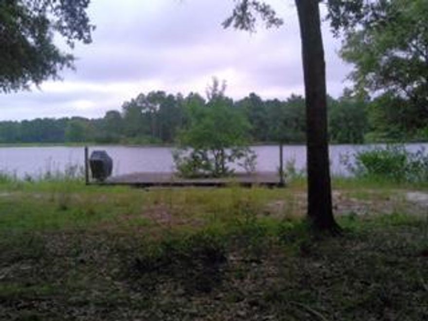 Beautiful Waterfront Lot on Juniper Lake.Property has a dock and a gate at the front entrance. Lake Juniper is a large, approx 700 foot Lake and is known as one of Florida's premier Bass Lakes. Come and enjoy some fantastic fishing and then sit back and enjoy a gorgeous Sunset on your very own Dock. Lot dimensions to be verified by Buyer.