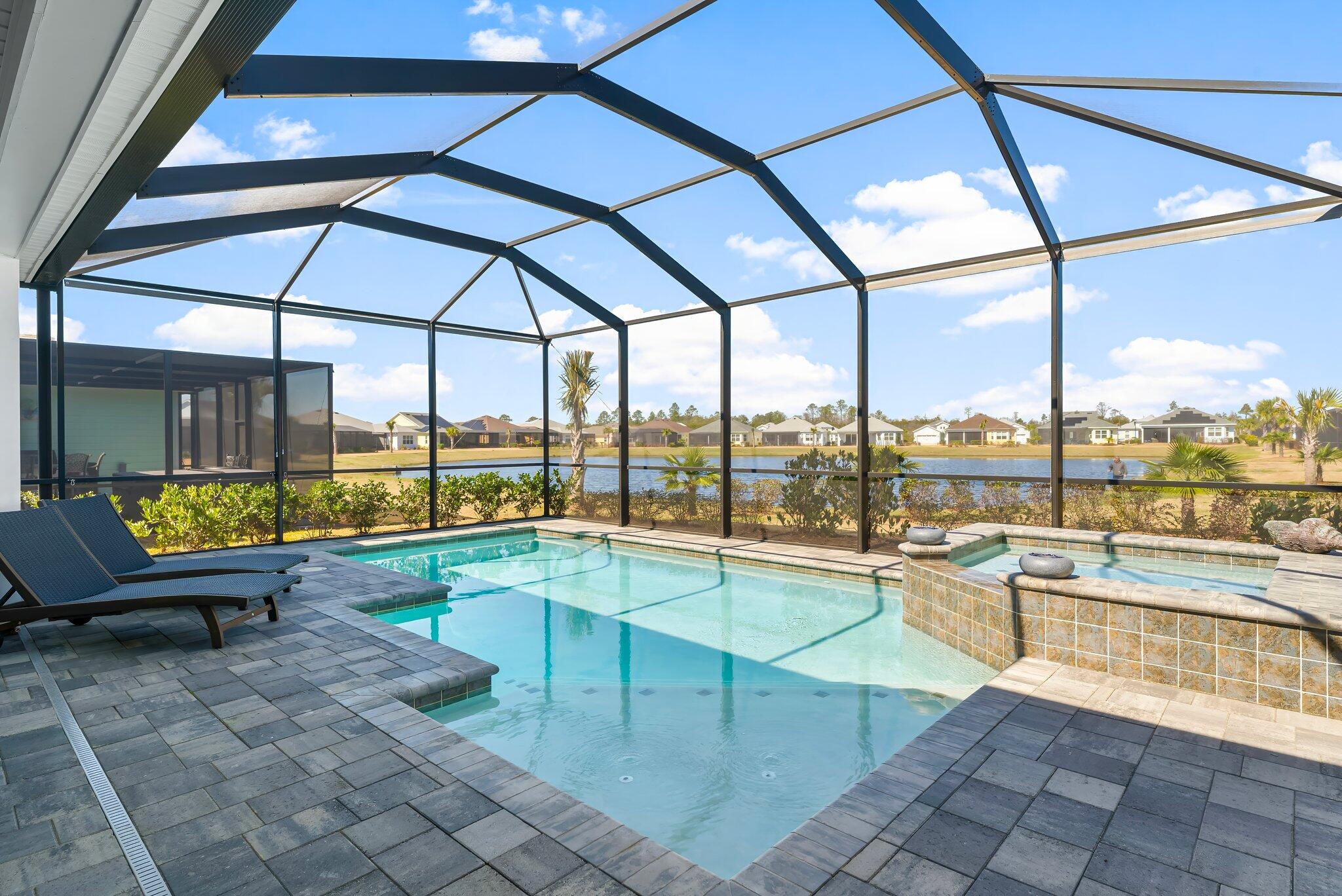 Come see this beautiful home, a one of a kind opportunity in the community of Latitude Margaritaville Watersound!  Rarely on the market and highly desired Aruba model with pond view, screened in pool, spa, and 3 car garage!  This sought-after Aruba floorplan home features 2 bedrooms plus den or 3rd bedroom, 2 and a half baths, gorgeous upgrades and a coveted location on a quiet street with close proximity to amenities.  Open the door and welcome to your private oasis, where no expense has been spared and no detail has been overlooked.  The finishes and upgrades were carefully selected, creating a blend of coastal elegance and comfort throughout the home.  Enjoy upgrades such as stone quartz countertops in every room (even the laundry room and back wall of kitchen), plantation   laminate floors throughout, custom crafted wood shelves in the closets, and a massive kitchen island with ample seating.  The kitchen also features upgraded cabinets, pull-out drawers, wine refrigerator, 5 burner gas stove, soft close cabinets and drawers, tons of storage and more.  This laundry room is most popular, and the largest laundry area, set just off the kitchen with cabinets galore and tons of counter space for a coffee station or whatever you desire.  Your screened-in back patio is a wonderful place to lounge or entertain, open your double sliding doors all the way to provide a grand entrance and combine your indoor and outdoor living spaces.  Enjoy your premium pond view, beautiful pool and spa, privacy sun shades and relax in one of your lovely spots for lounging, dining, and conversation.  This exquisite residence is the ideal spot to experience the lifestyle of the Latitude Margaritaville Watersound 55+ community; where comfort, sophistication and fun come together seamlessly.  Enjoy amenities in abundance, including HOA-maintained lawn care, sprinklers, a Town Square, paradise pool with beach entry cabanas, tiki huts, restaurant and bar with panoramic views of the intercoastal waterway, a state-of-the-art fitness center with workout equipment and exercise rooms and 75' lap pool, pickleball and tennis courts, bocce ball courts, kayak launch, dog park, walking trails, golf cart and biking paths, and more!  The community also boasts a bandshell for concerts, and an exciting calendar filled with parties, games and live music.  In addition, a brand new public marina is planned and will include both dry storage and wet slips. The marina will be located on the Intracoastal Waterway with convenient access to West Bay, Choctawhatchee Bay and the Gulf waters.  You are also just minutes to the beaches of Panama City Beach and the popular Pier Park for additional shopping and dining.  Whether you are relaxing or entertaining guests at homes or taking advantage of the many activities and amenities, this is the perfect space to enjoy both tranquility and the excitement of an active community.  Don't miss out on this extraordinary residence and the exceptional community of Latitude Margaritaville Watersound - call today!