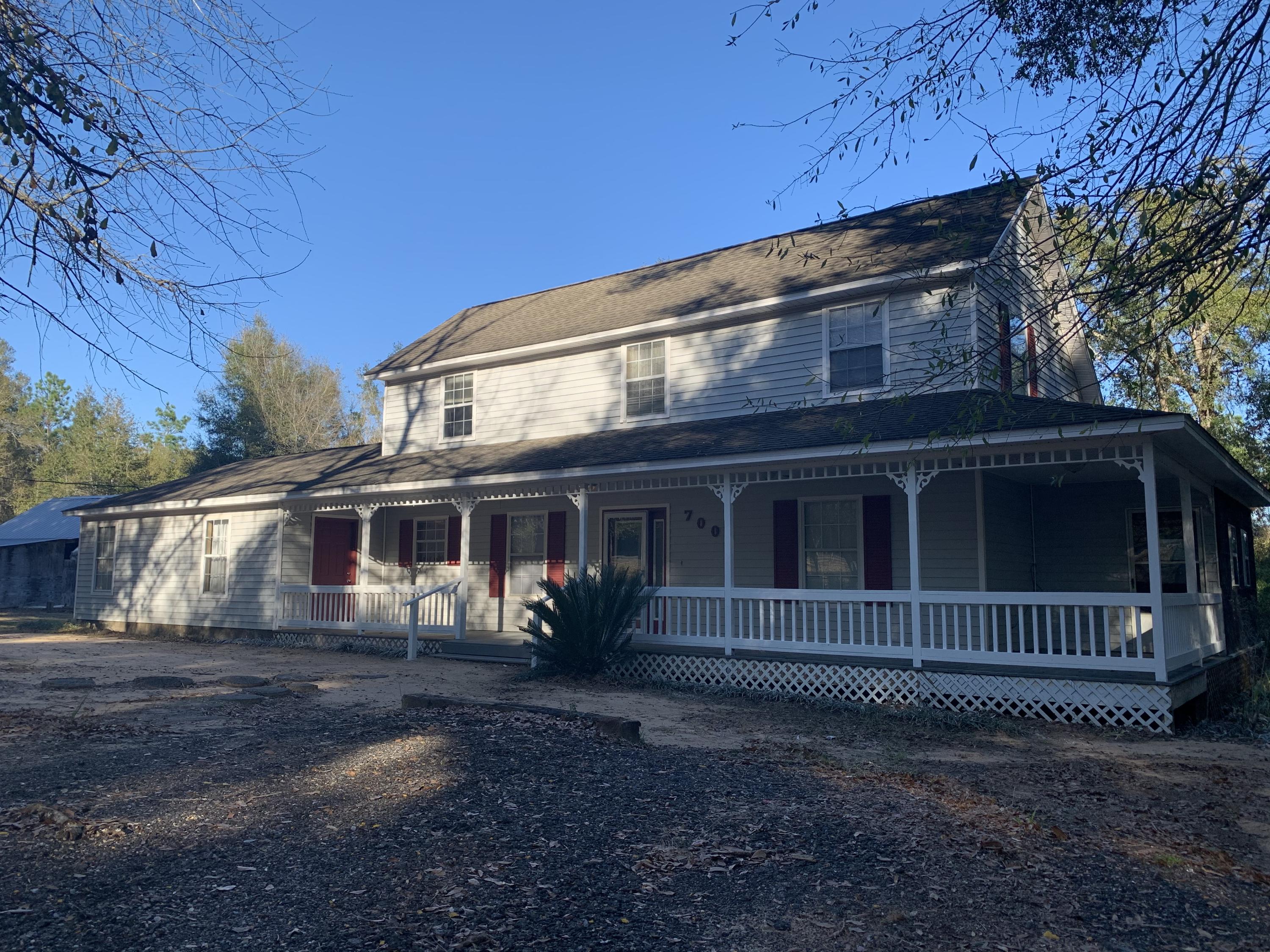 Motivated Sellers! This beautiful 2 story home with a partial wraparound porch is situated on 1.27 acres and backs up to the beautiful Blackwater Heritage State Trail. It features 4 bedrooms, one of which is located in the Mother-in-Law suite which has its own access into the house, with its own living room, bedroom, kitchen area, walk-in closet and handicap accessible bathroom. The master is located downstairs as well, with 2 additional bedrooms upstairs. Step out back to a fenced in area in the back yard, a grapevine, and a mulberry tree. Beautiful country setting, but still close to town. Don't let this one get away!