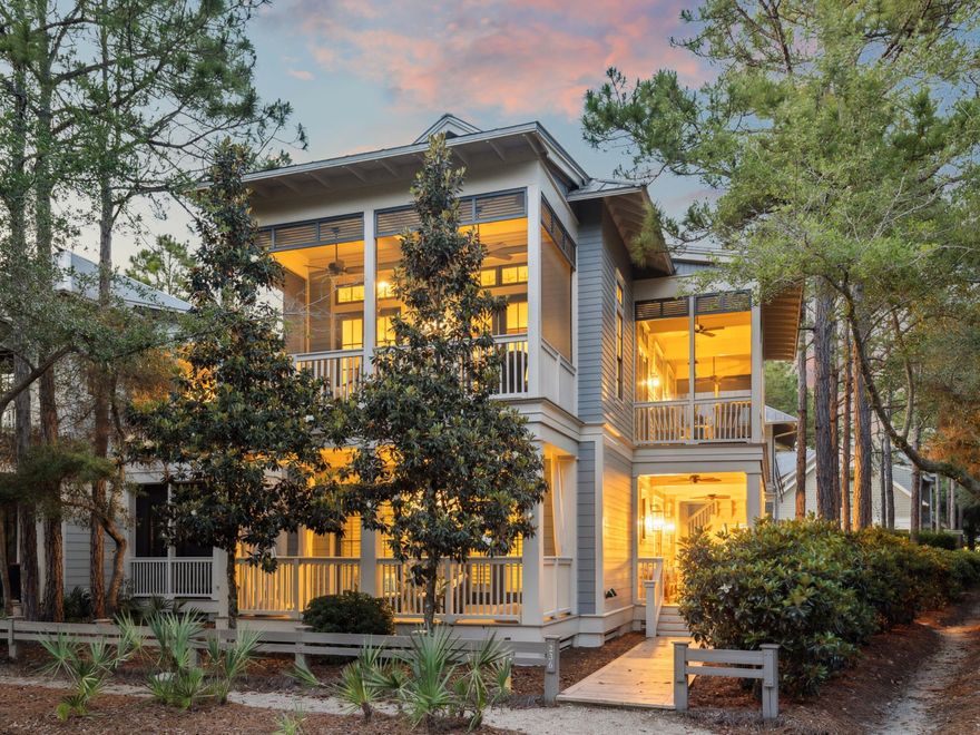 Located on a coveted corner lot directly across from Camp WaterColor, this five-bedroom, five-bathroom home offers a warm and welcoming blend of coastal elegance, natural beauty, and thoughtful design. Within the property, a beautifully furnished carriage house with private upstairs access enhances both function and flexibility--ideal for hosting guests, offering privacy for extended family, or creating an inspiring creative retreat. Expansive porchestotaling over 940 square feet extend the living area outdoors. The screened porch offers a tranquil setting for dining or unwinding, complete with a ceiling fan, porch swing, and tree-lined views. Downstairs, two custom-designed bunk rooms and guest suites provide flexible sleeping arrangements and private access to shaded porches, all filled with natural light and thoughtful details. Bathrooms throughout are finished with a mix of beadboard walls, natural tile, designer lighting, and wood-trimmed vanities, creating a cohesive, spa-like feel.

The main stairwell, with its rich wood treads and white-painted spindles, sets the tone for the home's polished, layered aesthetic. Every room feels intentionalsoft in tone, inviting in texture, and filled with light. Exterior upgrades include a detached two-car garage, two additional parking spaces, updated paint, and new gutters, all set within lush native landscaping that offers privacy and a serene setting just steps from Camp WaterColor's pools and green space.

Comfortably sleeping up to 14 guests, this fully furnished and rental-ready home embodies the best of WaterColor living: coastal charm, thoughtful craftsmanship, and a location that invites both connection and retreat.