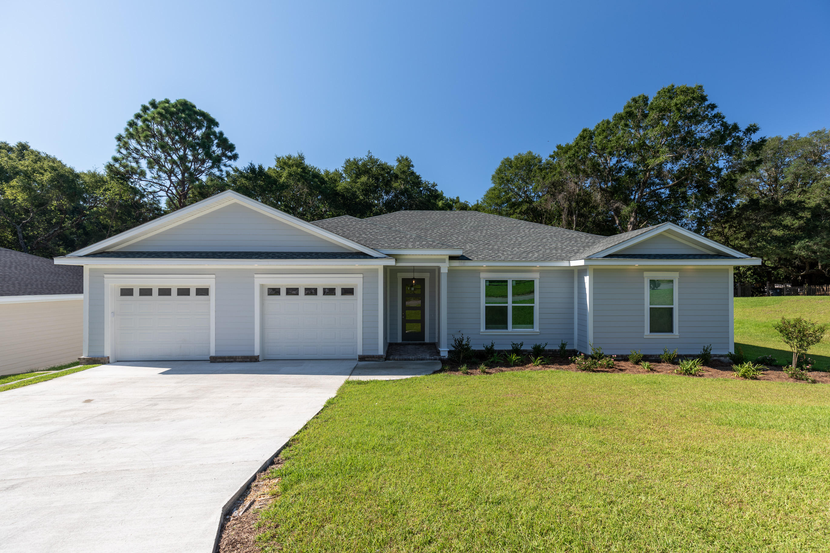 Beautiful brand new construction in the heart of Valparaiso just minutes from water access and Eglin AFB. Incredible quality of construction boasting 2x6 wall studs for stronger framing and additional insulation, sturdy fiber cement board siding, and impact glass windows up to 150 mph rating. Gulf Power certified energy efficient ''Earth Cents'' home, GAF heavy duty 30-year shingles, whole house automatic generator, Goodman heat pump air conditioner, Rinnai tankless hot water heater, spray foam insulation in roof, manabloc plumbing system, 10 foot ceilings, LED lighting throughout, and waterproof flooring. Kitchen is loaded with stainless steel Maytag energy efficient appliances, large farm house sink and tiled back splash. Kitchen and bathrooms offer custom cabinets built