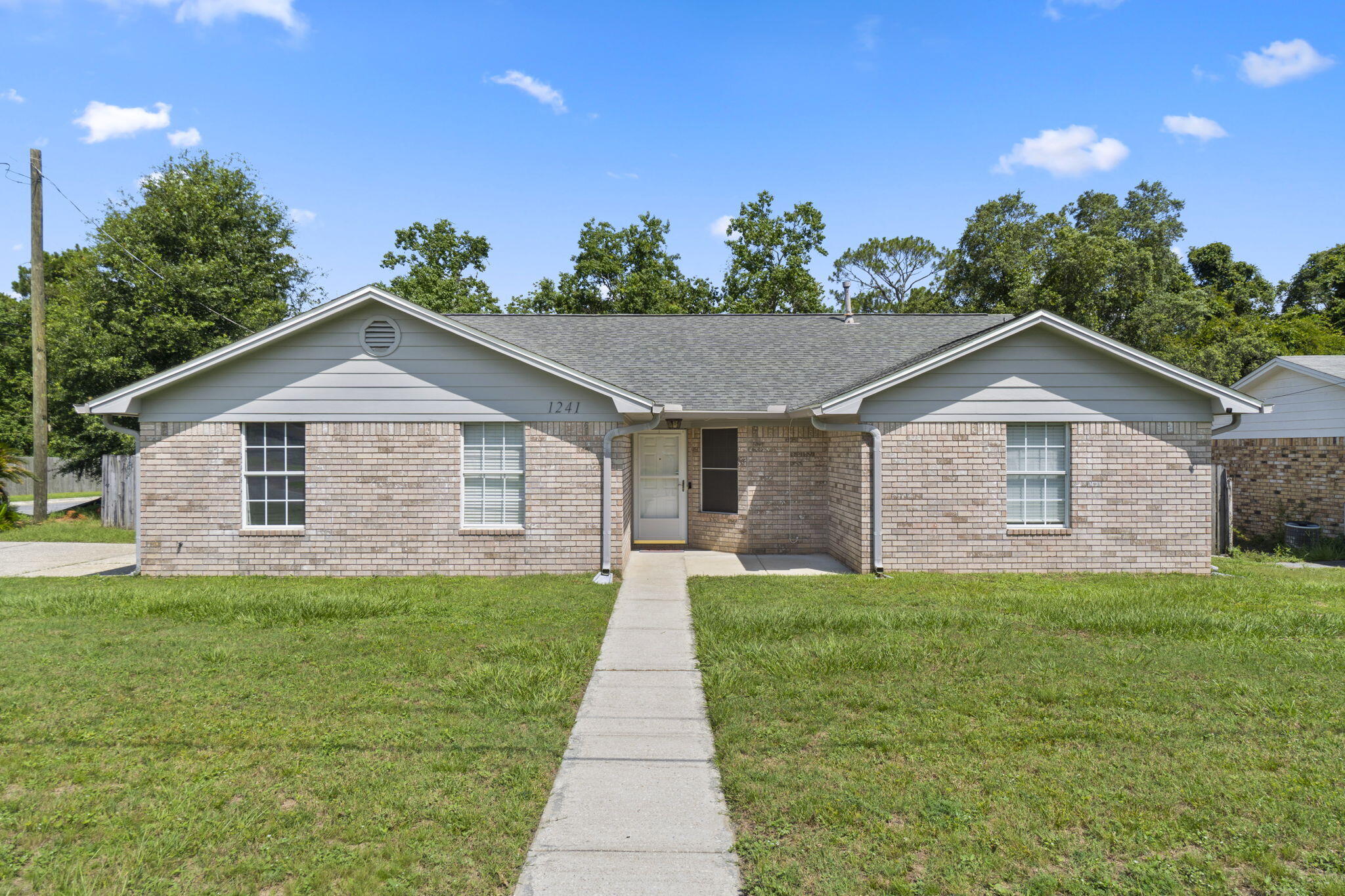 Near to the beaches & NAS Pensacola. Welcome to your beautiful Ranch home (Corner Lot) in Woodbridge Manor. Enjoy a ;large primary bedroom with an en suite bathroom featuring a walk in shower. The split floor plan was recently upgraded with new vinyl plank flooring in all bedrooms & tile through the rest of the house. Enjoy the open kitchen area that flows into the great room and dining area. This has been freshly painted. Fenced in backyard and large concrete patio area (42 x 14). New Roof 2021, New HVAC 6/22, New gas water heater 11/22, New walk in shower 2022.
