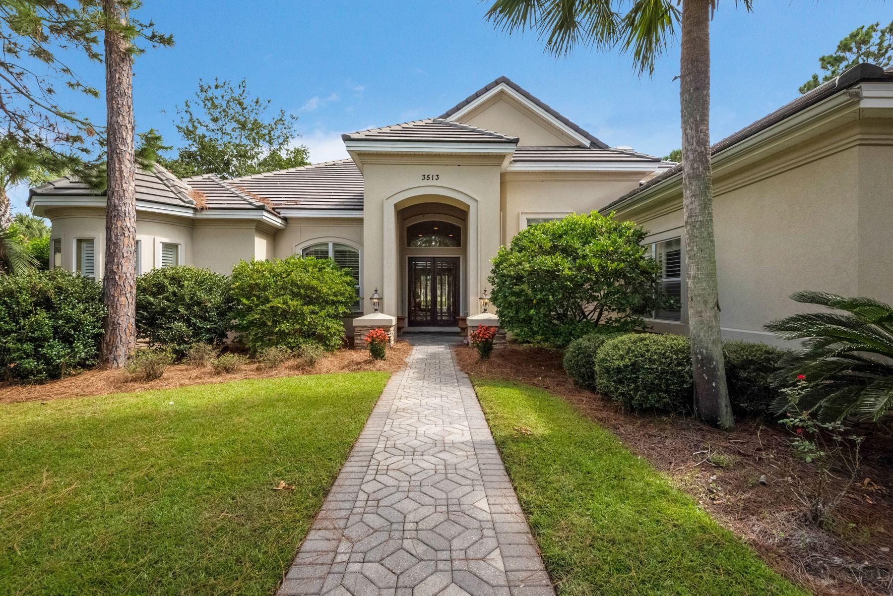 This lakefront estate in the prestigious gated neighborhood of Burnt Pine offers open architecture with astonishing indoor and outdoor living space, ideal for entertaining. French doors invite you into the expansive 30' saltwater pool with 6 person hot tub, the perfect spot for rest and relaxation. This premium location provides surprising privacy and picturesque views of the renowned Burnt Pine golf course and a tranquil lake. Imagine hosting a family barbecue from the outdoor kitchen with Thermador Grill, Pecky Cypress ceilings and direct access to the full pool bath. Relax and read a book in the plush seating area of your master suite with private access to the pool. The master bath with dual vanities, soaker tub and separate shower with 6 spray nozzles will pamper you with its spa-like