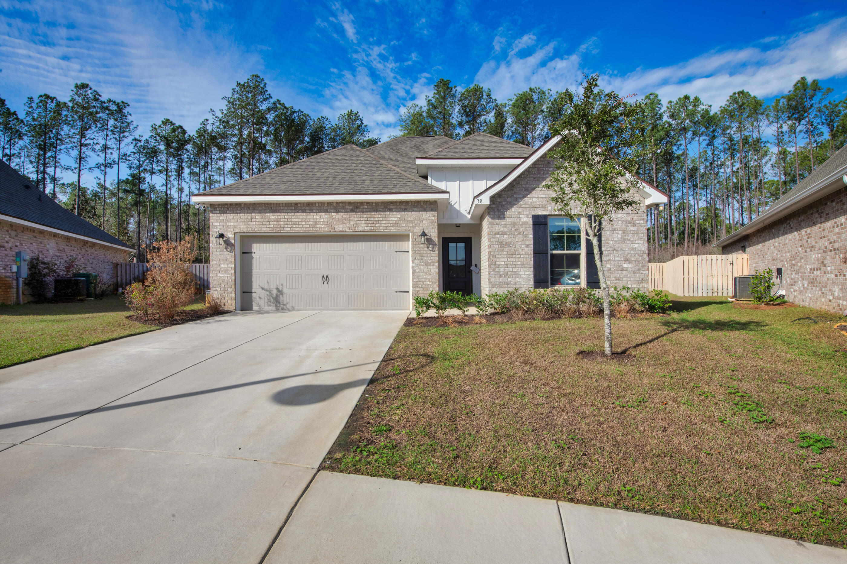 Tucked away at the end of a peaceful cul-de-sac in the highly sought-after Hammock Bay community, this charming 4-bedroom, 3-bathroom home offers a prime location for those seeking both tranquility and convenience. You'll enjoy access to the full range of amenities in Hammock Bay, including pools, tennis and pickleball courts, sports fields, a boathouse, clubhouse, and bay access. Plus, with the exciting new amenities currently being built in the south portion of the community, there's even more to look forward to. Just a short walk away, you can fish or relax by the bay while taking in stunning sunset views. Experience all of the perks of an almost brand-new home that was built in 2023, you will enjoy sleek quartz countertops, upgraded cabinets, blinds, ceramic tile throughout the commonand wet areas and a full complement of appliances. The spacious primary suite features a large walk-in closet and a private bathroom with a walk-in shower and garden tub. The fenced-in backyard offers peace and privacy, backing up to serene woods, where you will relax or entertain on the covered outdoor patio. This home is the perfect blend of quiet living and vibrant community life.