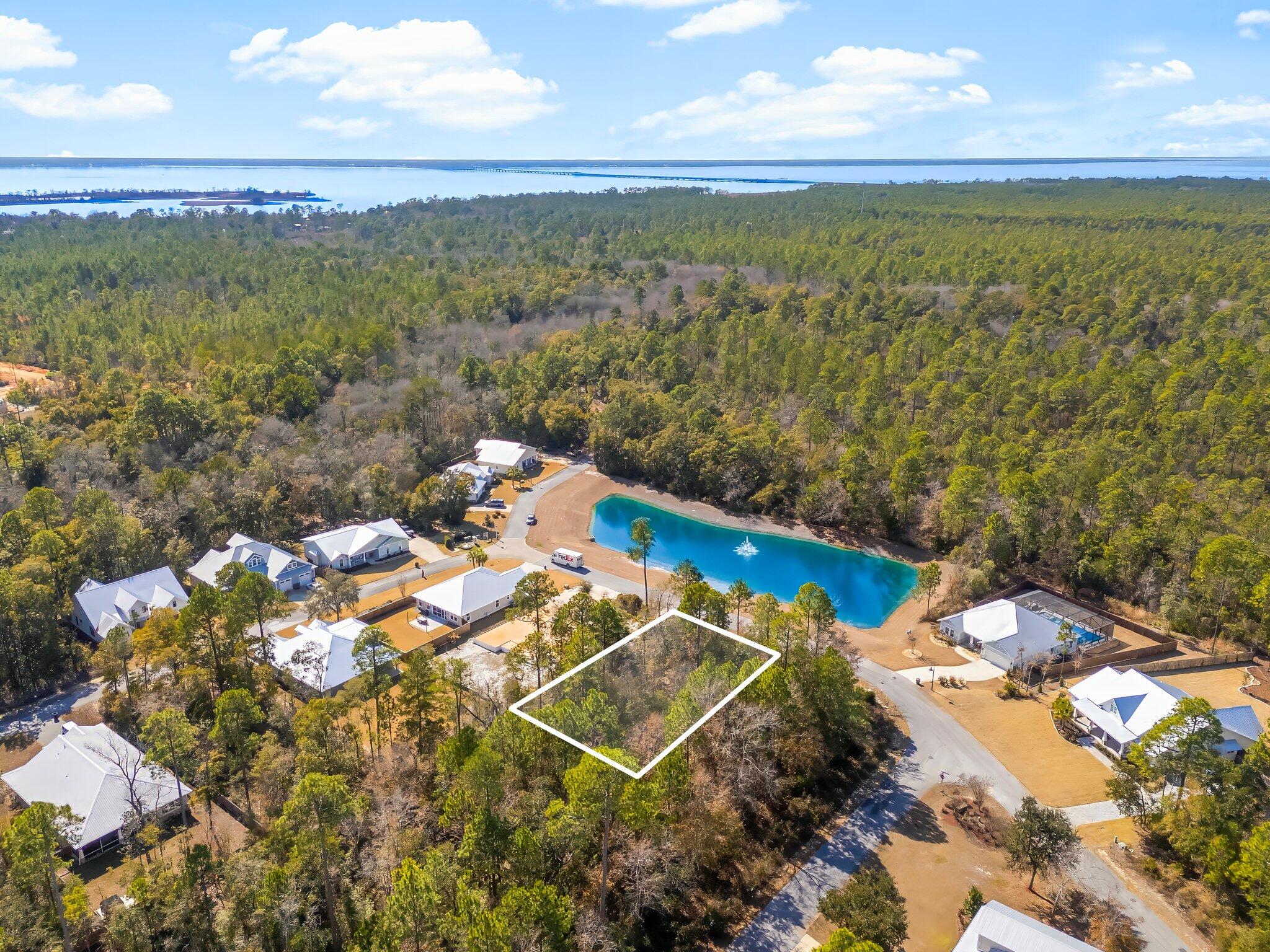 Located right across the street from the water, Lot 53 Hibernate Way, provides an excellent opportunity to own in one of Florida's premier neighborhoods.Nestled along Florida's Emerald Coast, right over the 331 bridge, Bear Creek is a scenic gated community that makes owning paradise a reality. Residents enjoy pickleball, tennis, a pool, a playground, and a fitness center. A resort-style pool and additional pickleball courts are coming in Phase 3's amenities center, which is currently under construction. Bear Creek's slogan is ''Closer To Everything", and location is its best asset. It is conveniently located minutes from beaches, major highways, bayfront parks, boat ramps, docks, public fishing piers, and waterfront dining. Bear Creek is a short drive from the international airport & charming coastal towns on Scenic Hwy 30a. Bear Creek ensures the amenities are for residents only by banning vacation rentals.