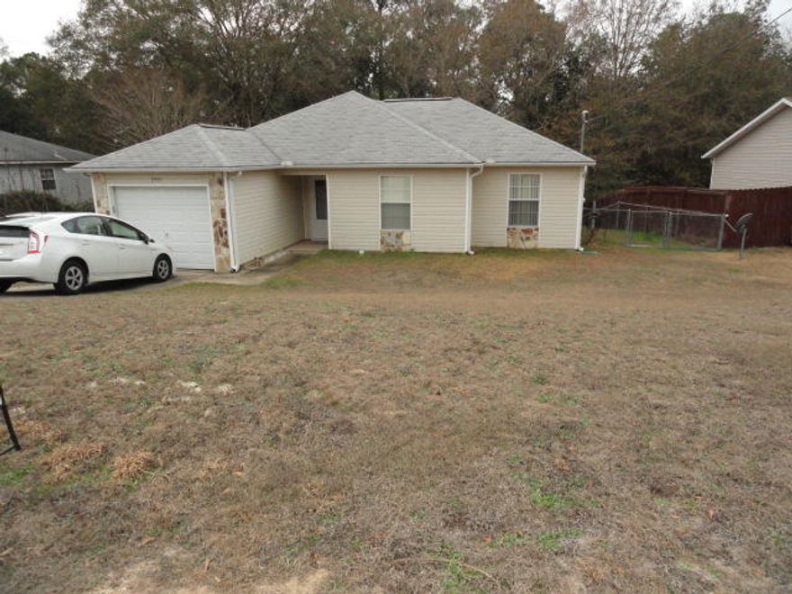 Goldilocks would find this house ''just right''! This one owner home has been loved and cared for. It is situated on 1.26 acre lot with a little stream flowing behind the fence. The owner built a retaining wall with walk ways over the stream. Off the rear of the home you will find a covered rear porch and a open deck on separate levels. Rear fenced yard and a storage building. The home has a large living room, the wall mount TV will be left for the owner. The Kitchen has updated appliances that will remain with the home. The floors are tile thru out the living area and carpet in the bedrooms. Outside you will find a few flowering shrubs, fig trees, and other fruit bearing trees.
