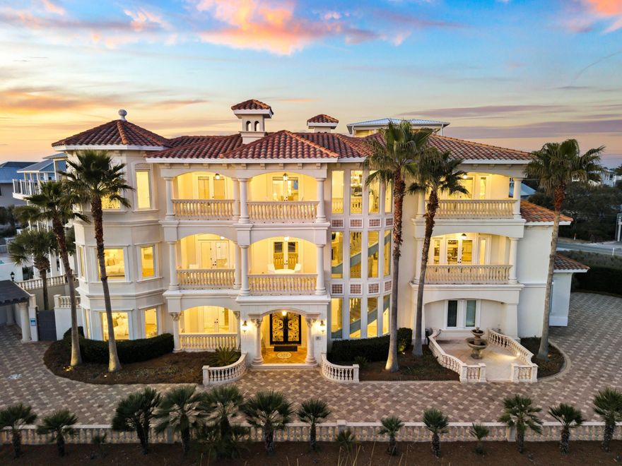 Positioned within the gated enclave of Pelican Circle along Scenic Highway 30A, this exceptional coastal residence offers a rare opportunity just moments from the Gulf's white sand shoreline and the rare coastal dune waters of Camp Creek Lake. Tucked behind private gates and set within one of the area's most discreet beachside corridors, the property pairs architectural presence with a location defined by both exclusivity and natural beauty. Spanning more than 5,500 square feet, the home is thoughtfully designed to balance expansive gathering spaces with private retreats, all oriented to capture sweeping views and seamless indoor-outdoor living. An elevator provides effortless access to each level, ensuring both convenience and long-term livability without compromise. In 2025, the residence underwent a comprehensive interior refresh, including full interior repainting, all new designer furnishings, updated lighting throughout, and new pool equipment, enhancing both its aesthetic appeal and operational performance.

The arrival experience is both striking and intentional. A circular drive and custom pergola frame the approach, leading to a dramatic iron entry. Inside, soaring ceilings and generous proportions create an immediate sense of scale. The first floor is designed with both entertainment and functionality in mind, featuring a spacious bunk room ideal for hosting multiple guests and a dedicated movie theater that transforms evenings into a private cinematic experience.

At the center of the outdoor living experience, a secluded courtyard is enclosed by a tall stone wall, offering privacy rarely found this close to the beach. A heated pool and spa, complemented by a built-in grotto and cascading waterfall, create a resort-style setting equally suited for quiet mornings or elevated entertaining.

The second level introduces the main living space, anchored by a chef's kitchen and dining area designed for gathering. Multiple balconies extend the living areas outward, capturing Gulf views from the front and serene pool views from the rear. Two additional king suites share a well-appointed bath with a walk-in shower and dressing area, providing comfort and privacy for family or guests.

On the top floor, a glass-enclosed fitness room, secondary laundry, and powder bath add convenience and flexibility. A guest primary suite enjoys its own private balcony and spa-inspired bath, while the main primary suite commands the home's most compelling Gulf views. Complete with an expansive terrace, custom dressing room, heated bathroom floors, soaking tub, and walk-in shower, it serves as a true private sanctuary above the coastline.

Primely positioned within gated Pelican Circle, just steps from the beach and minutes from the natural beauty of Camp Creek Lake, this recently refreshed residence offers a compelling blend of lifestyle, privacy, and long-term value. With exceptional scale, resort-caliber amenities, elevator access, and meaningful upgrades completed in 2025, it represents a rare offering along 30A for those seeking refined coastal living with enduring investment potential.