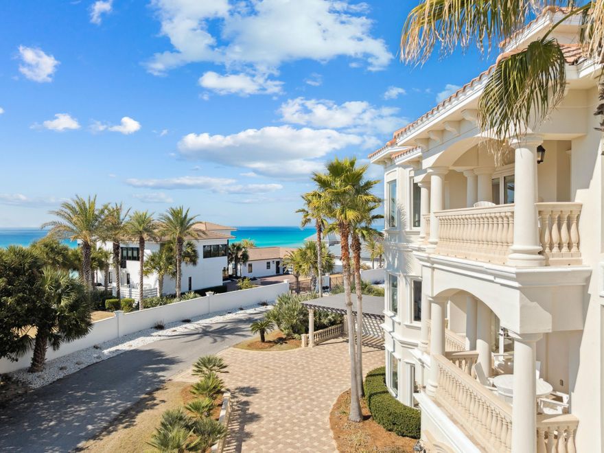 Positioned within the gated enclave of Pelican Circle along Scenic Highway 30A, this exceptional coastal residence offers a rare opportunity just moments from the Gulf's white sand shoreline and the rare coastal dune waters of Camp Creek Lake. Tucked behind private gates and set within one of the area's most discreet beachside corridors, the property pairs architectural presence with a location defined by both exclusivity and natural beauty. Spanning more than 5,500 square feet, the home is thoughtfully designed to balance expansive gathering spaces with private retreats, all oriented to capture sweeping views and seamless indoor-outdoor living. An elevator provides effortless access to each level, ensuring both convenience and long-term livability without compromise. In 2025, the residence underwent a comprehensive interior refresh, including full interior repainting, all new designer furnishings, updated lighting throughout, and new pool equipment, enhancing both its aesthetic appeal and operational performance.

The arrival experience is both striking and intentional. A circular drive and custom pergola frame the approach, leading to a dramatic iron entry. Inside, soaring ceilings and generous proportions create an immediate sense of scale. The first floor is designed with both entertainment and functionality in mind, featuring a spacious bunk room ideal for hosting multiple guests and a dedicated movie theater that transforms evenings into a private cinematic experience.

At the center of the outdoor living experience, a secluded courtyard is enclosed by a tall stone wall, offering privacy rarely found this close to the beach. A heated pool and spa, complemented by a built-in grotto and cascading waterfall, create a resort-style setting equally suited for quiet mornings or elevated entertaining.

The second level introduces the main living space, anchored by a chef's kitchen and dining area designed for gathering. Multiple balconies extend the living areas outward, capturing Gulf views from the front and serene pool views from the rear. Two additional king suites share a well-appointed bath with a walk-in shower and dressing area, providing comfort and privacy for family or guests.

On the top floor, a glass-enclosed fitness room, secondary laundry, and powder bath add convenience and flexibility. A guest primary suite enjoys its own private balcony and spa-inspired bath, while the main primary suite commands the home's most compelling Gulf views. Complete with an expansive terrace, custom dressing room, heated bathroom floors, soaking tub, and walk-in shower, it serves as a true private sanctuary above the coastline.

Primely positioned within gated Pelican Circle, just steps from the beach and minutes from the natural beauty of Camp Creek Lake, this recently refreshed residence offers a compelling blend of lifestyle, privacy, and long-term value. With exceptional scale, resort-caliber amenities, elevator access, and meaningful upgrades completed in 2025, it represents a rare offering along 30A for those seeking refined coastal living with enduring investment potential.