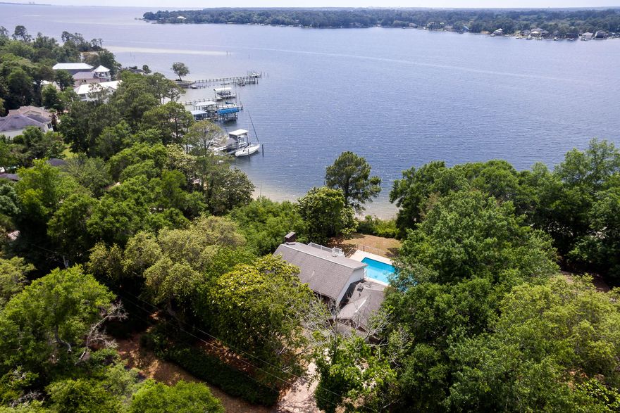 STUNNING waterfront property on the quiet, deep water of Rocky Bayou with AMAZING sunset views!! This one owner, custom built colonial home on a .42 acre lot offers 4 bedrooms and multiple living areas as well as a pool for summertime fun. When you enter ''Newport House'' you will find the formal dining room on the right and the living room on the left. The living room is open to the family room and sunroom beyond that so you can enjoy the Bayou views from wherever you may be. On the other side of the family room you will find the kitchen and breakfast nook, also with bayou views. All the bedrooms are upstairs including the master suite with French doors leading out to a balcony with wonderful views of the bayou, back yard and pool. This property is NOT in a flood zone and the natural shoreline allows for plenty of summertime fun swimming and splashing in Rocky Bayou. Properties like this don't come on the market too often so don't miss out on your chance to own your own piece of paradise!