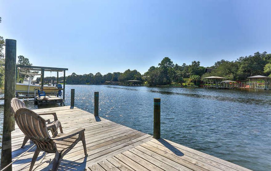 RARE FIND! Waterfront home complete with dock and boat launch located on a protected bayou of Chotawhatchee Bay. This NEWLY RENOVATED all brick home is incredibly fun! Fresh exterior paint, interior paint, floors, doors, bathrooms, vanities, appliances......URBAN in style. Clean, simple, spacious two bedroom + bonus room that could be a guest suite, sunken family room or office. Spacious family room opens to kitchen with large windows overlooking the bayou and dock. Mature landscaping includes Gardenia bushes, ornamental bamboo, banana palms, lillies and an awesome shade tree with rope swing. Enourmous canopy of shade stretches beyond the covered rear porch and patio. The waterline is bulkheaded with L shaped dock and includes an easy access boat launch.