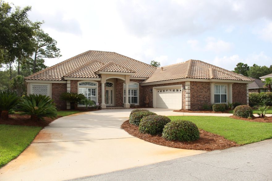Welcome home to your pristine golf course villa in Windward! As you enter this magnificent home, your formal dining room is to your right complete with tray ceiling. The foyer opens up to your formal sitting room with sliding glass doors out to your screened-in patio. The entrance to your office enveloped in built-in shelving is off the sitting room with a convenient hall bath. Further into this wing of the home is the master suite: hardwood floors, tray ceiling, crown molding, and natural light galore. There is also an entrance to the screened-in patio from the master suite. The master bathroom has his-and-her closet space, separate double vanity sinks, a walk-in shower, and sunk-in garden tub. Back through the sitting room is your living room and kitchen open concept design. The perfect layout for entertaining guests. There is a breakfast nook to your left and the kitchen opens up to your right. Massive island, stainless steel appliances, Sub-Zero refrigerator, Viking 6-burner stove, and a hooded vent - a chef's dream kitchen. You have the perfect view from your kitchen to look out over the golf course and lake. The living room has a screened-in porch entrance, fireplace, built-in shelving, and trey ceiling complete with rope lighting. On the other wing of the house is the laundry room with tons of cabinet space, a utility sink, and hose storage for your central vacuum system. To your left is an additional bedroom with access to an outdoor patio and its own bathroom. To your right is another hall bathroom and access to the second bedroom for optimal privacy for your guests. Going back out into the screened-in patio there are additional cabinets for storage and a utility sink. The backyard has wonderful and unobstructed view of the Bluewater Bay Golf Course. Two car oversize garage with a golf-cart door. Stairway to storage attic space above the garage is a plus-no pull down stairs to climb up. Sprinkler system in place to keep your manicured lawn in tip top shape the neighbors will envy.